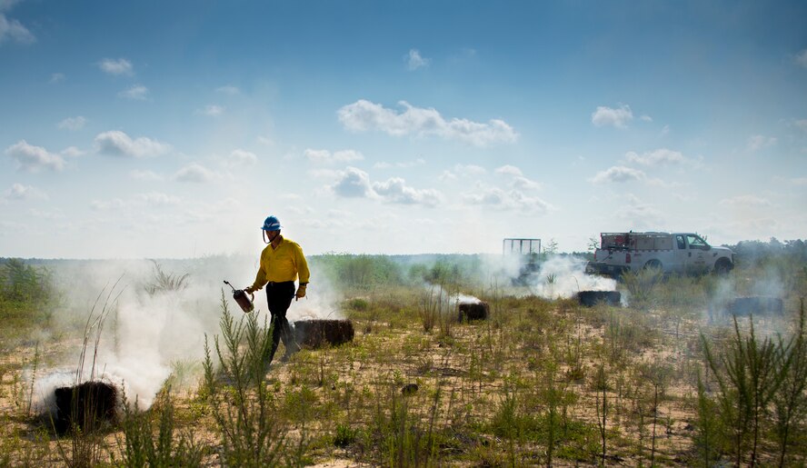 CJ Mahon, a Jackson Guard firefighter, lights hay on fire for a recent exercise at Duke Field Fla.  The members of Jackson Guard’s wildland fire center are responsible for controlling and maintaining Eglin’s natural resources and operations areas through controlled burning of the it’s forests.  (U.S. Air Force photo/Tech. Sgt. Jasmin Taylor)