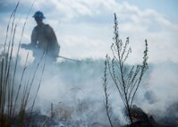 Aaron Radford, a Jackson Guard firefighter, works to put out a smoldering fire after a recent exercise at Duke Field Fla.  The members of Jackson Guard’s wildland fire center are responsible for controlling and maintaining Eglin’s natural resources and operations areas through controlled burning of the it’s forests.  (U.S. Air Force photo/Tech. Sgt. Jasmin Taylor)