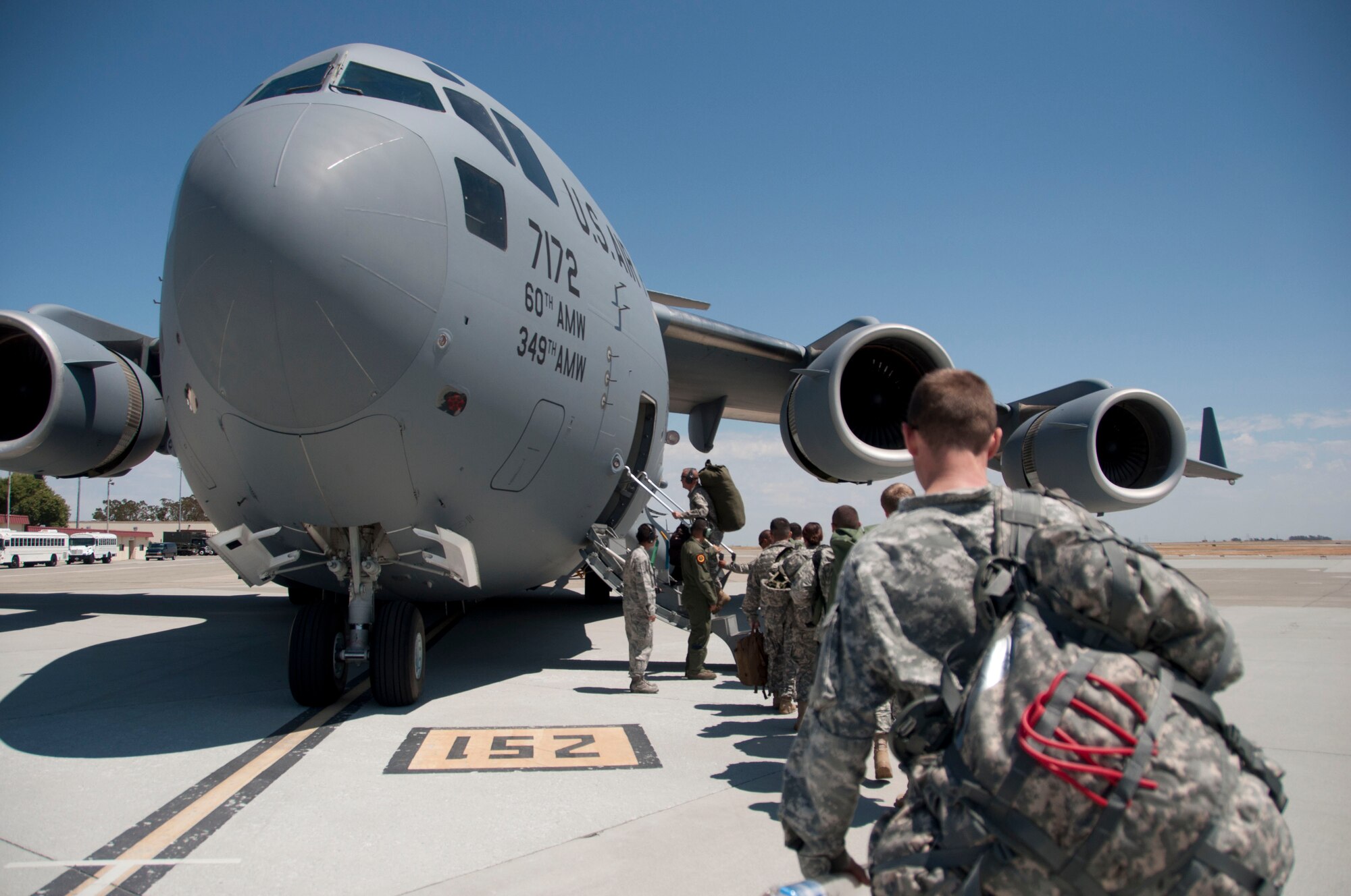 The 49th Military Police Brigade boards a C-17 Globemaster III Aug. 11 at Travis Air Force Base. The 60th Aerial Port Squadron at Travis and the 49th MP BDE National Guard unit work together to complete a joint service training exercise (U.S. Air Force photo by Airman 1st Class Amber Carter) 