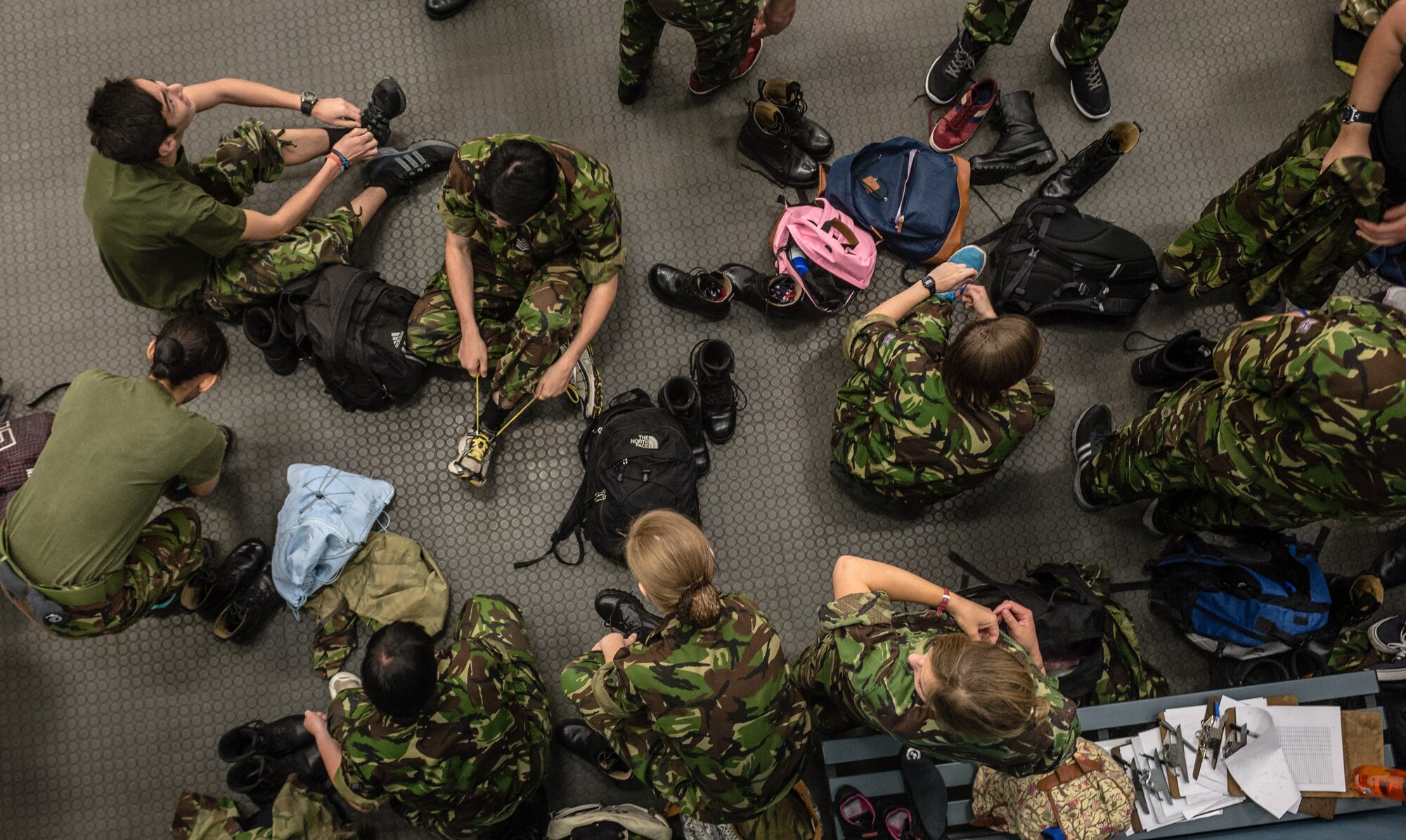 British cadets from the Air Training Corps, change out of their combat boots to prepare for a physical training class on Vogelweh Military Complex, Germany, Aug. 14, 2014. The cadets from England, Whales and Northern Ireland took part in the event that immersed them into the life of a U.S. Air Force NCO attending the Kisling NCOA. (U.S. Air Force photo/Airman 1st Class Jordan Castelan)