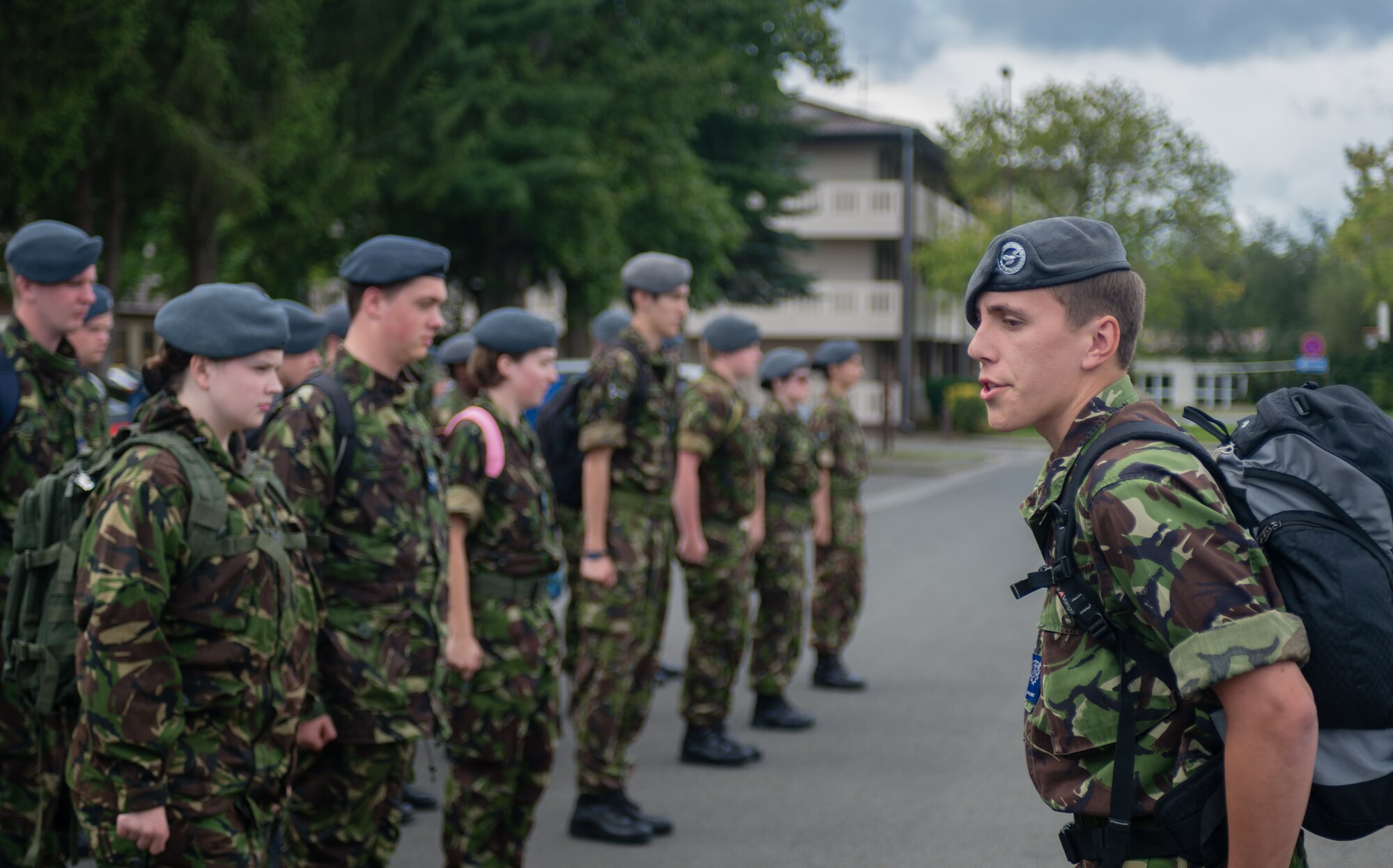 British Air Training Corps Detachment Warrant Officer Mathew Craigs, 224th ATC, calls a group of more than 40 British cadets to attention in front of the Kisling Noncommissioned Officer Academy on Vogelweh Military Complex, Germany, Aug. 14, 2014. The cadets from England, Whales and Northern Ireland took part in the event that immersed them into the life of a U.S. Air Force NCO attending the Kisling NCOA. (U.S. Air Force photo/Airman 1st Class Jordan Castelan)