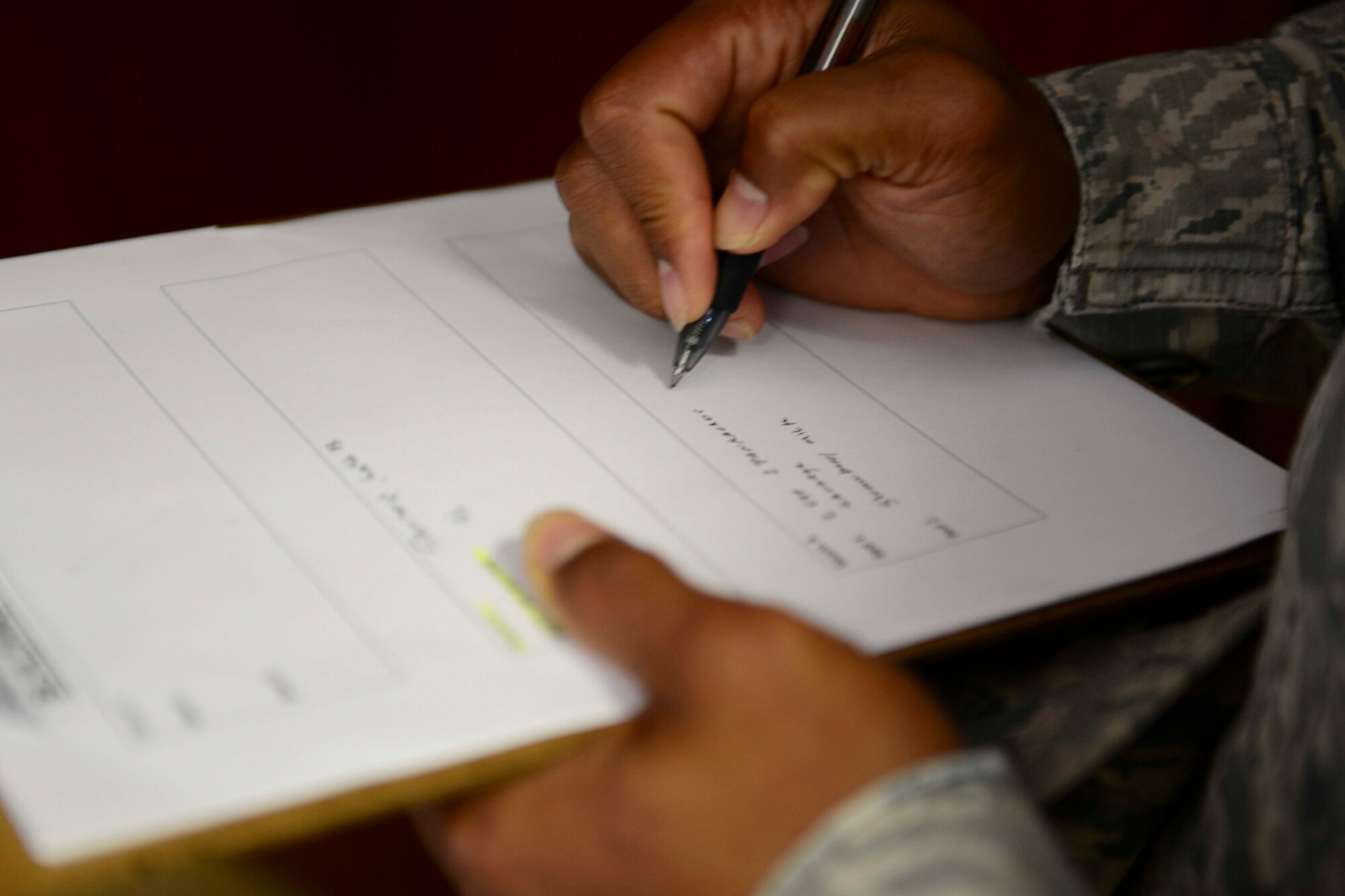 U.S. Air Force Staff Sgt. Boaz Etpison, 379th Expeditionary Civil Engineer Squadron, writes down a breakfast order for a breakfast in bed program at Al Udeid Air Base, Qatar, Aug. 10, 2014. The program is designed to deliver breakfast to Service members that are at AUAB in the Intra-Theater Care Program to recover from injuries. (U.S. Air Force photo by Staff Sgt. Ciara Wymbs) 