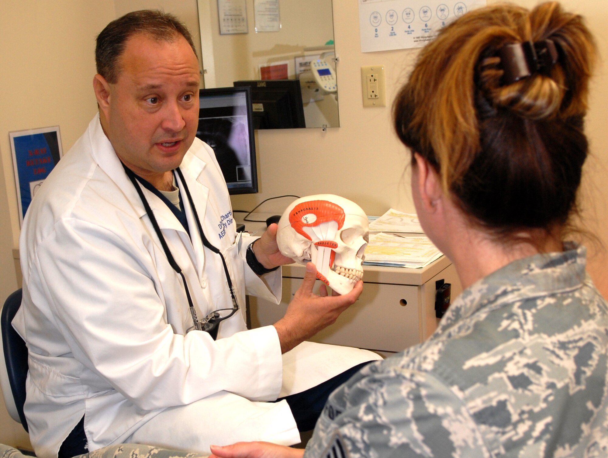 Lt. Col. Stephen Chartier, 78th Dental Squadron commander, shows Jessica Wilber, 116th Air Control Wing retention officer, how the jaw and muscles work. (US. Air Force photo by Misuzu Allen)