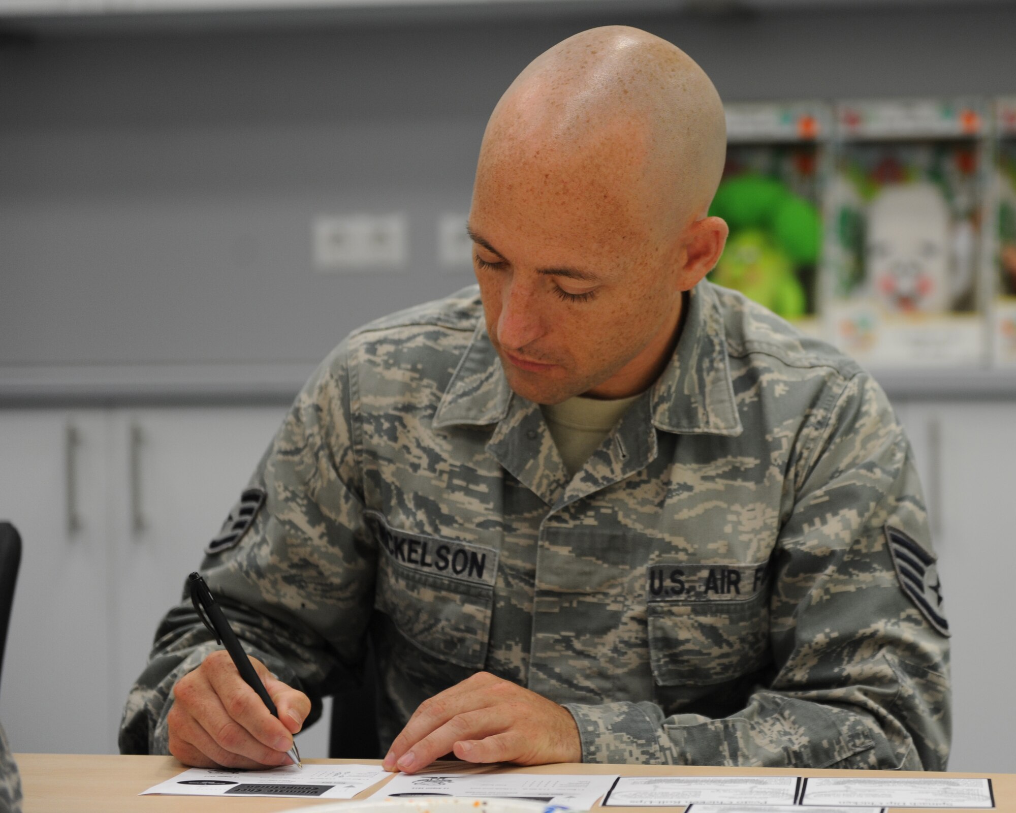U.S. Air Force Staff Sgt. Aaron Mickelson, a 52nd Equipment Maintenance Squadron combat plans and mobility supervisor, writes his score for each meal during the Ultimate Chef competition Aug. 13, 2014, at Spangdahlem Air Base, Germany. More than 15 Sabers attended and judged the competition, awarding U.S. Air Force Tech. Sgt. David Levine, 52nd Equipment Maintenance Squadron NCO in charge of munitions stock control, the title of “Ultimate Chef.” (U.S. Air Force photo by Airman 1st Class Dylan Nuckolls/Released)