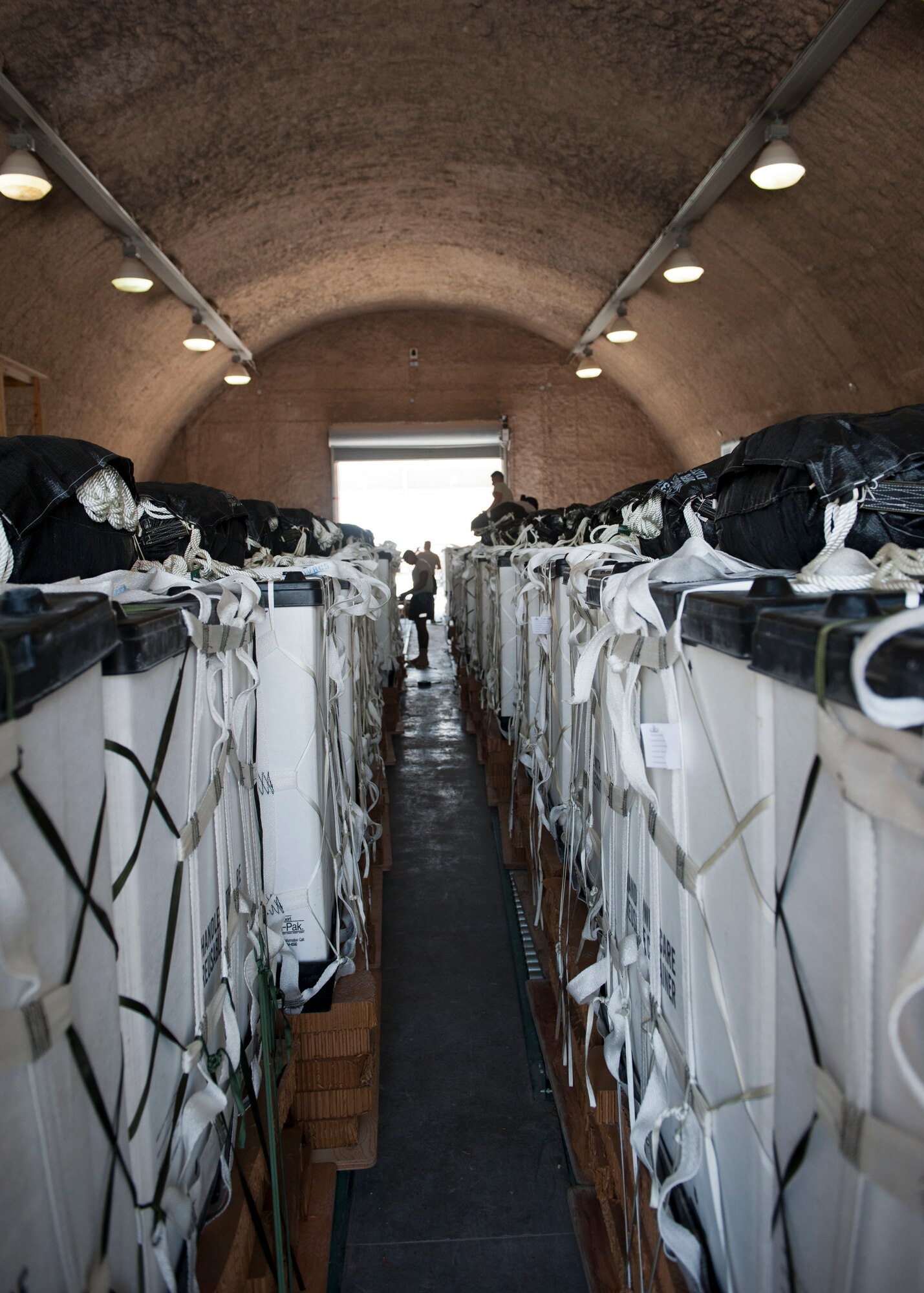 Completed pallets are lined up, to be transported onto an aircraft at Al Udeid Air Base, Qatar, Aug. 13, 2014. Volunteers from across the base came out to help build pallets of humanitarian aid. The pallets are being airdropped to displaced citizens in the vicinity of Sinjar, Iraq. (U.S. Air Force photo by Senior Airman Colin Cates)