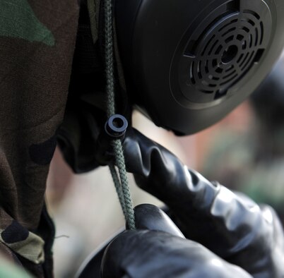 U.S. Air Force Staff Sgt. Kevin Saunders, 100th Maintenance Group Quality Assurance inspector from Rockledge, Fla., checks the clip of an Airman’s Mission-Oriented Protective Posture gear during a chemical, biological, radiological and nuclear training class Aug. 14, 2014, at building 680 on RAF Mildenhall, England. Buddy checks involve checking each snap, strap and seal, and help ensure the maximum protection from possible CBRN contamination. (U.S. Air Force photo/Senior Airman Kate Maurer/Released)