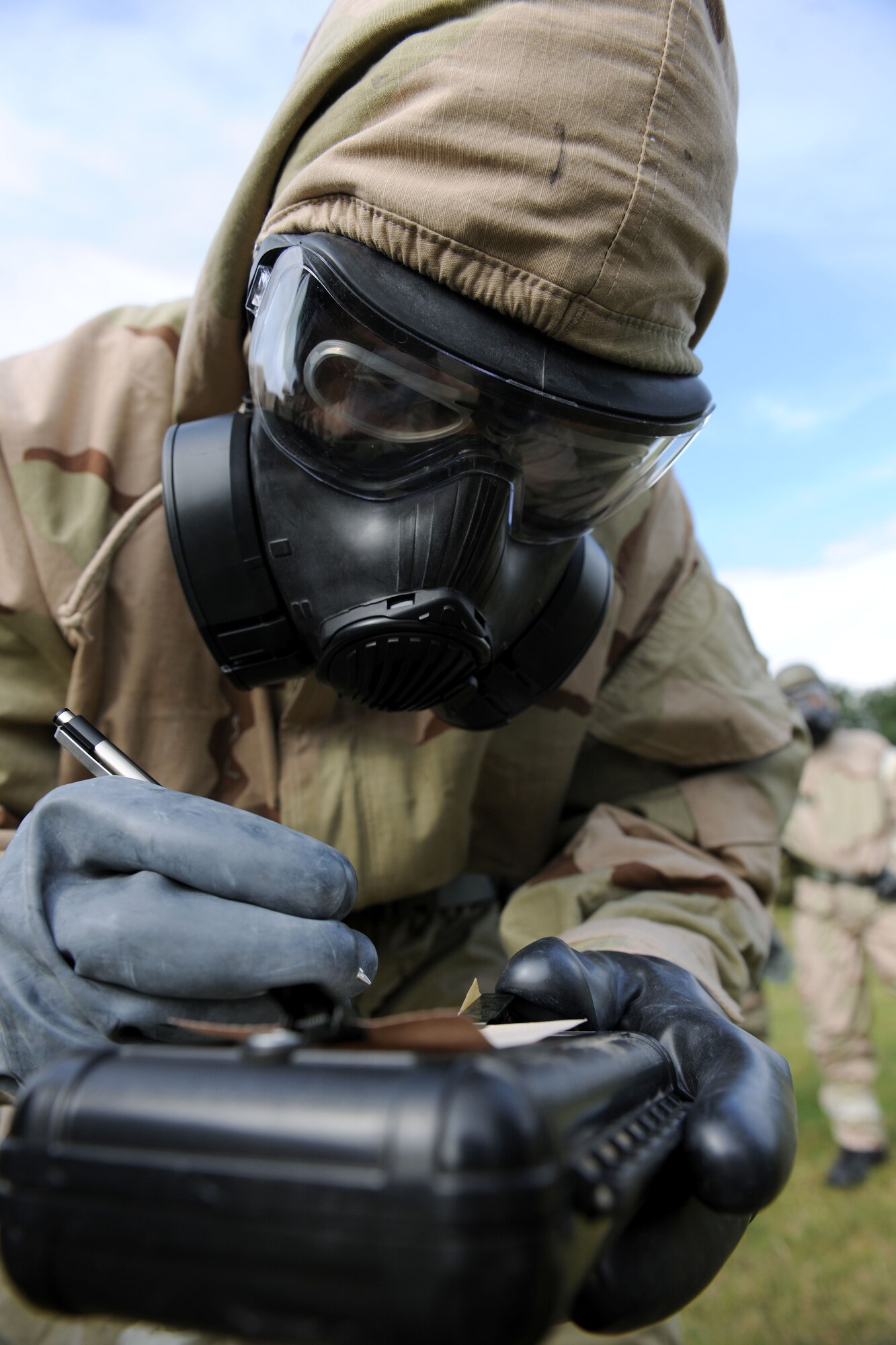 U.S. Air Force Senior Airman Charles Fincher, 100th Aircraft Maintenance Squadron KC-135 Stratotanker crew chief from Douglasville, Ga., labels M-9 paper during a chemical, biological, radiological and nuclear training class Aug. 14, 2014, at building 680 on RAF Mildenhall, England. The M-9 paper is used as a way to detect and identify chemical weapons in a CBRN situation. (U.S. Air Force photo/Senior Airman Kate Maurer/Released)
