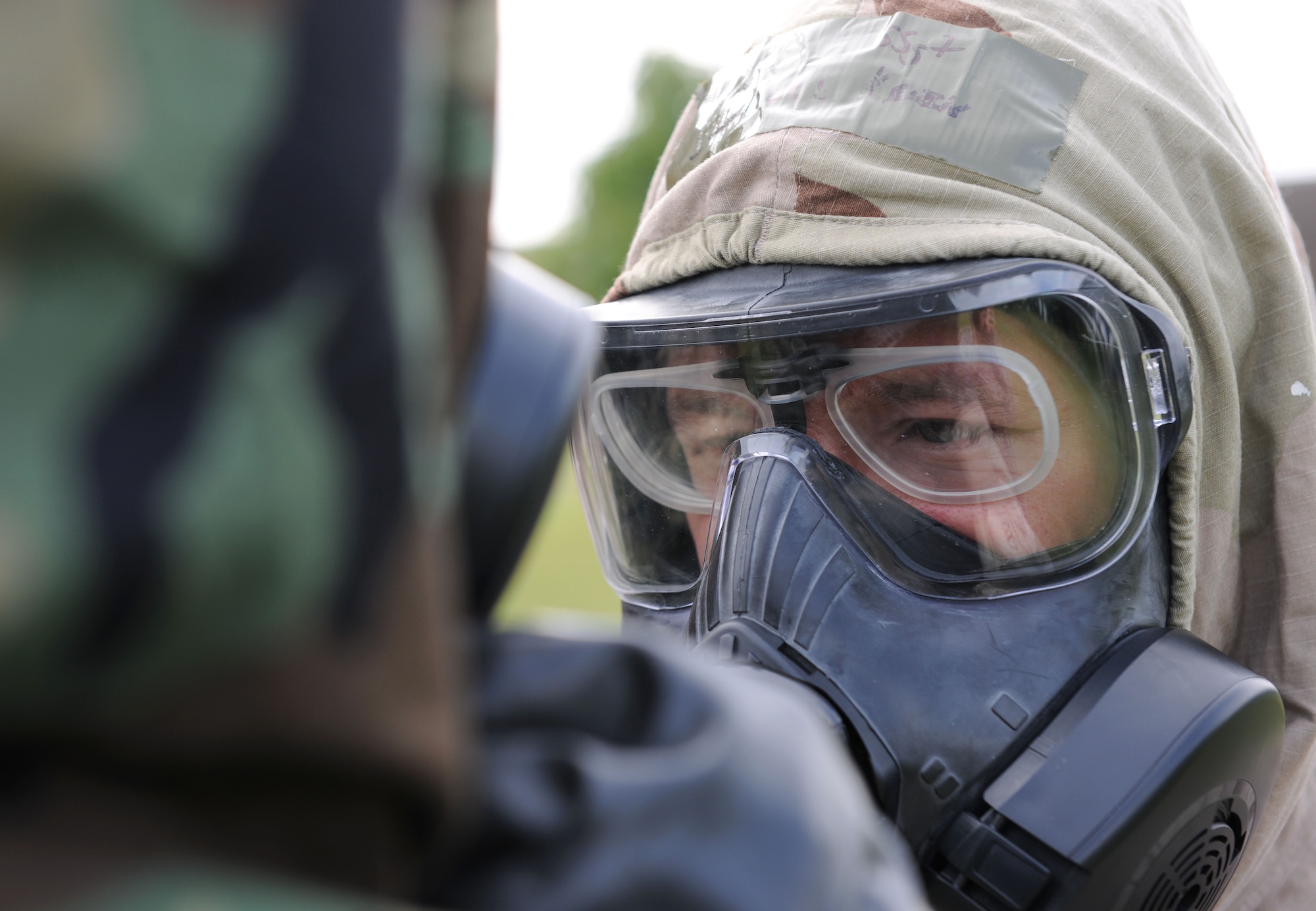 U.S. Air Force Staff Sgt. Kevin Saunders, 100th Maintenance Group Quality Assurance inspector from Rockledge, Fla., checks an Airman’s Mission-Oriented Protective Posture gear during a chemical, biological, radiological and nuclear training class Aug. 14, 2014, at building 680 on RAF Mildenhall, England. During MOPP Level Four, personnel are required to wear the maximum amount provided protection equipment and clothing. (U.S. Air Force photo/Senior Airman Kate Maurer/Released)