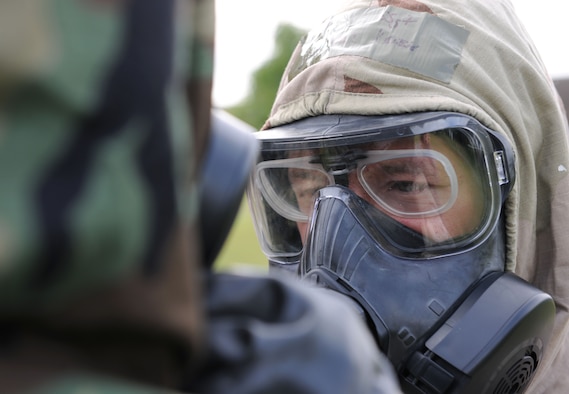 U.S. Air Force Staff Sgt. Kevin Saunders, 100th Maintenance Group Quality Assurance inspector from Rockledge, Fla., checks an Airman’s Mission-Oriented Protective Posture gear during a chemical, biological, radiological and nuclear training class Aug. 14, 2014, at building 680 on RAF Mildenhall, England. During MOPP Level Four, personnel are required to wear the maximum amount provided protection equipment and clothing. (U.S. Air Force photo/Senior Airman Kate Maurer/Released)