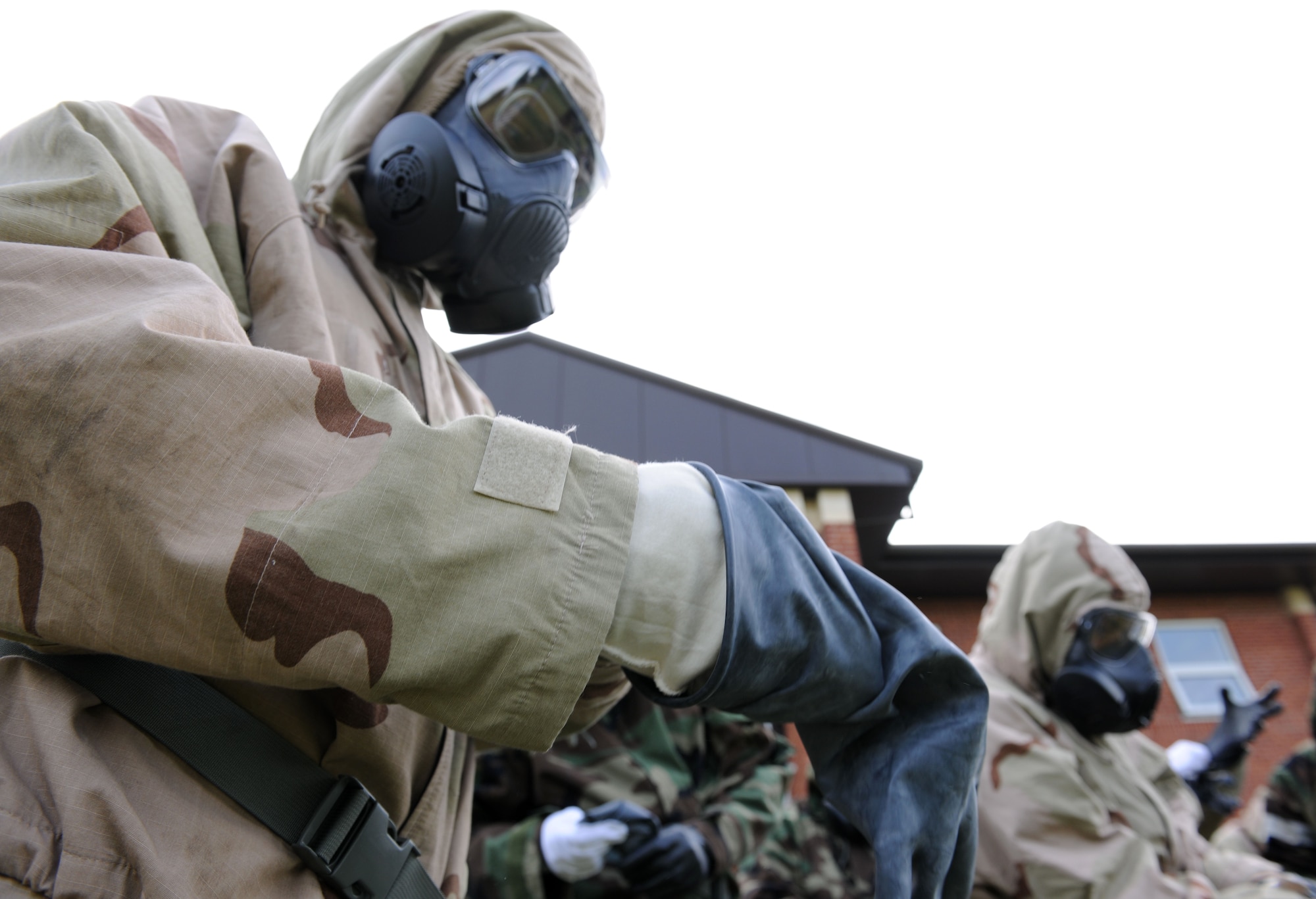 U.S. Air Force Senior Airman Charles Fincher, 100th Aircraft Maintenance Squadron KC-135 Stratotanker crew chief from Douglasville, Ga., puts on his gloves during a chemical, biological, radiological and nuclear training class Aug. 14, 2014, at building 680 on RAF Mildenhall, England. During training, Airmen learned about Mission-Oriented Protective Postures and how to react in the event of a CBRN situation. (U.S. Air Force photo/Senior Airman Kate Maurer/Released)