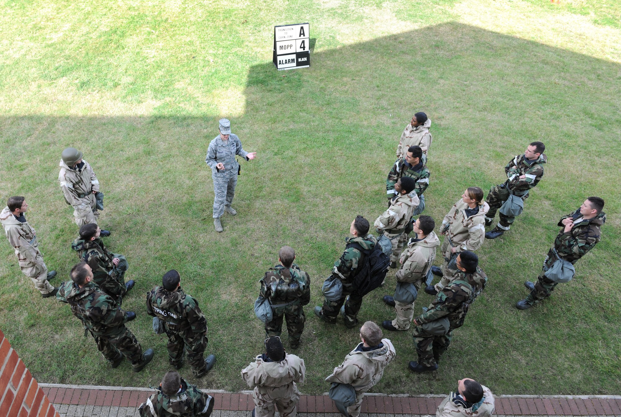 U.S. Air Force Senior Airman Dena Kirkman, 100th Civil Engineer Squadron Emergency Management specialist from Camdenton, Mo., teaches a chemical, biological, radiological and nuclear training class to Team Mildenhall Airmen Aug. 14, 2014, at building 680 on RAF Mildenhall, England. The emergency management flight conducts weekly CBRN survival skills classes to train and keep the base prepared to respond to specific CBRN threats. (U.S. Air Force photo/Senior Airman Kate Maurer/Released)