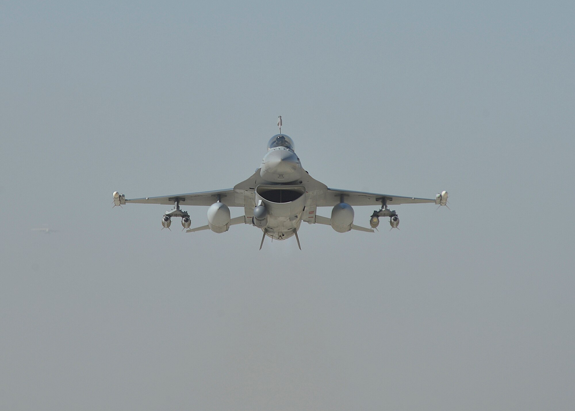 A U.S. Air Force F-16 “Fighting Falcon” with the 100th Expeditionary Fighter Squadron “Red Tails” flies over Afghanistan at Bagram Airfield, Afghanistan Aug. 7, 2014. The mission of the F-16 “Fighting Falcon” here is to provide tactical air-to-air and air-to-ground support for Operation Enduring Freedom.  The unit is deployed from the 187th Fighter Wing in Montgomery, Ala. (U.S. Air Force photo by Staff Sgt. Evelyn Chavez/Released)