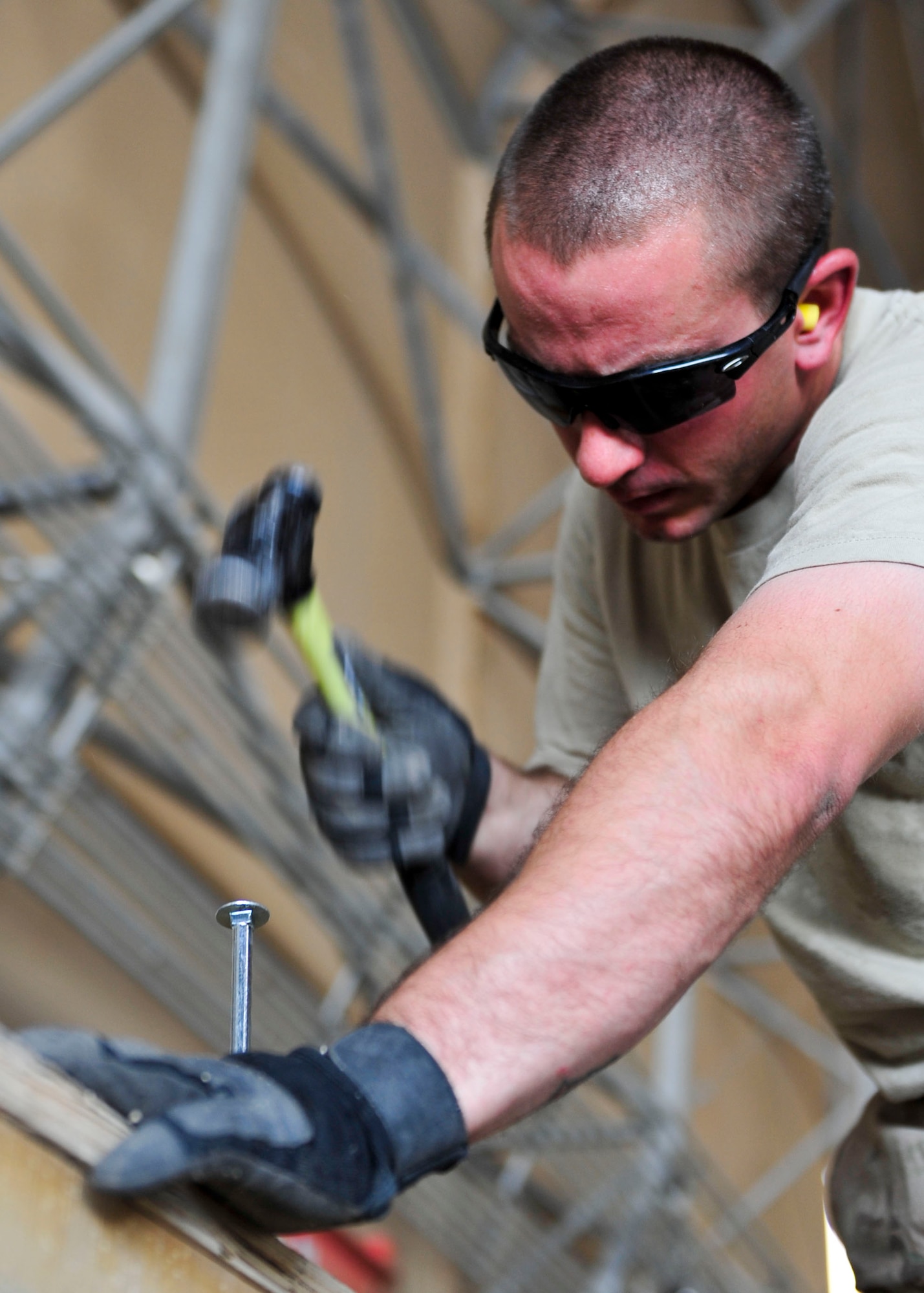U.S. Air Force Staff Sgt. Jason Johnson, 340th Expeditionary Air Refueling Squadron Detachment 1 traffic management office inbound and outbound manager, measures a board for pallet construction at Mazar-i-Sharif Airfield, July 24, 2014. Johnson is responsible for ensuring mission critical parts get shipped to the area of responsibility and are properly transported. Johnson is deployed from Joint Base Lewis-McChord, Washington. (U.S. Air Force photo by Senior Airman Colin Cates) 