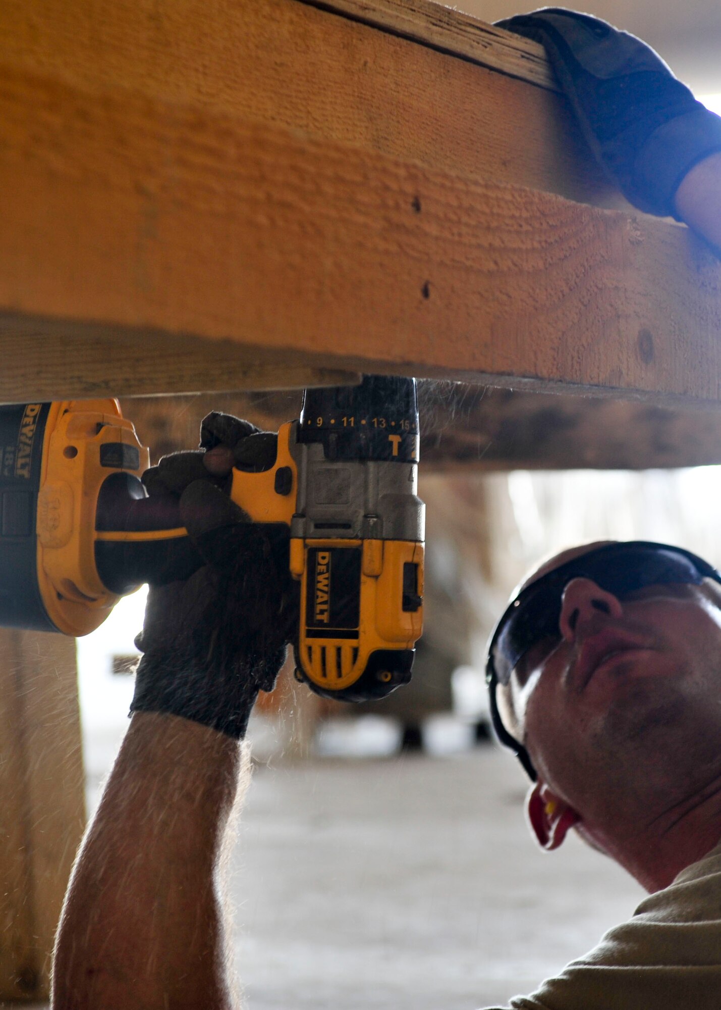 U.S. Air Force Staff Sgt. Jason Johnson, 340th Expeditionary Air Refueling Squadron Detachment 1 traffic management office inbound and outbound manager, measures a board for pallet construction at Mazar-i-Sharif Airfield, July 24, 2014. Johnson is responsible for ensuring mission critical parts get shipped to the area of responsibility and are properly transported. Johnson is deployed from Joint Base Lewis-McChord, Washington. (U.S. Air Force photo by Senior Airman Colin Cates) 
