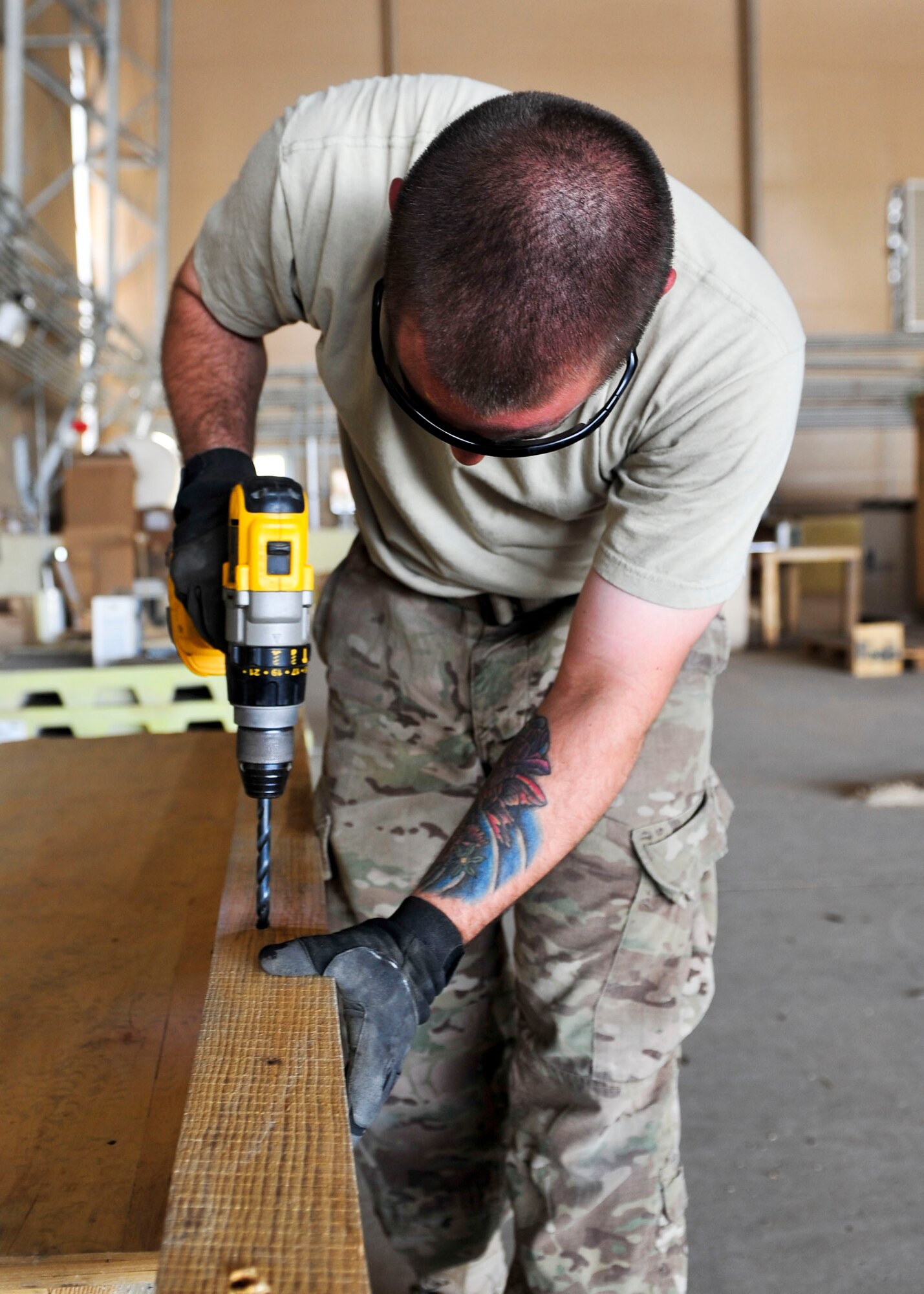 U.S. Air Force Staff Sgt. Jason Johnson, 340th Expeditionary Air Refueling Squadron Detachment 1 traffic management office inbound and outbound manager, measures a board for pallet construction at Mazar-i-Sharif Airfield, July 24, 2014. Johnson is responsible for ensuring mission critical parts get shipped to the area of responsibility and are properly transported. Johnson is deployed from Joint Base Lewis-McChord, Washington. (U.S. Air Force photo by Senior Airman Colin Cates) 