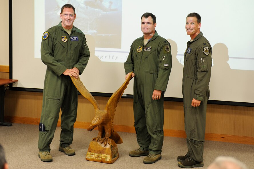 Members from the 44th Fighter Squadron receive the Top Fighter Squadron trophy at the 18th Wing’s 2014 Turkey Shoot on Kadena Air Base, Japan, Aug. 14, 2014. The award was presented to the 44th FS as a result of their performance in a bi-lateral training exercise with Japan Air Self-Defense Force members, an academic test of tactical knowledge and visual recognition and a friendly one-on-one competition against the 67th FS. (U.S. Air Force photo by Senior Airman Maeson Elleman/Released)
