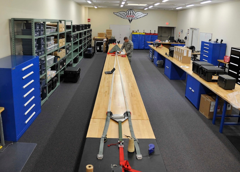 U.S. Air Force Airman 1st Class Parker Taylor, 35th Operations Support Squadron Aircrew Flight Equipment apprentice, packs a parachute at Misawa Air Base, Japan, July 31, 2014. With the parachute spread out, Taylor inspects and secures the risers and suspension lines ensuring there are no discrepancies between the canopy and harness. (U.S. Air Force photo by Airman 1st Class Patrick S. Ciccarone/Released) 