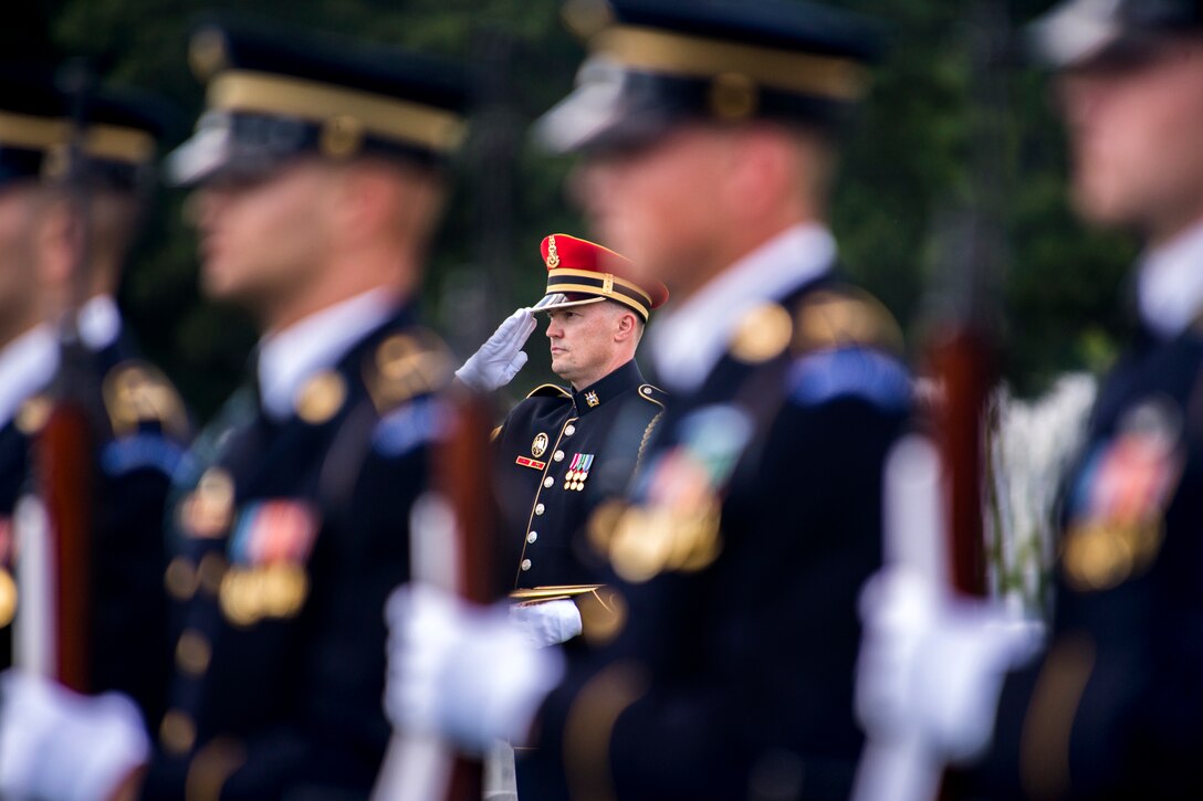 An Army bugler salutes during a military funeral to honor Army Maj. Gen. Harold J. Greene at Arlington National Cemetery in Arlington, Va., Aug. 14, 2014.