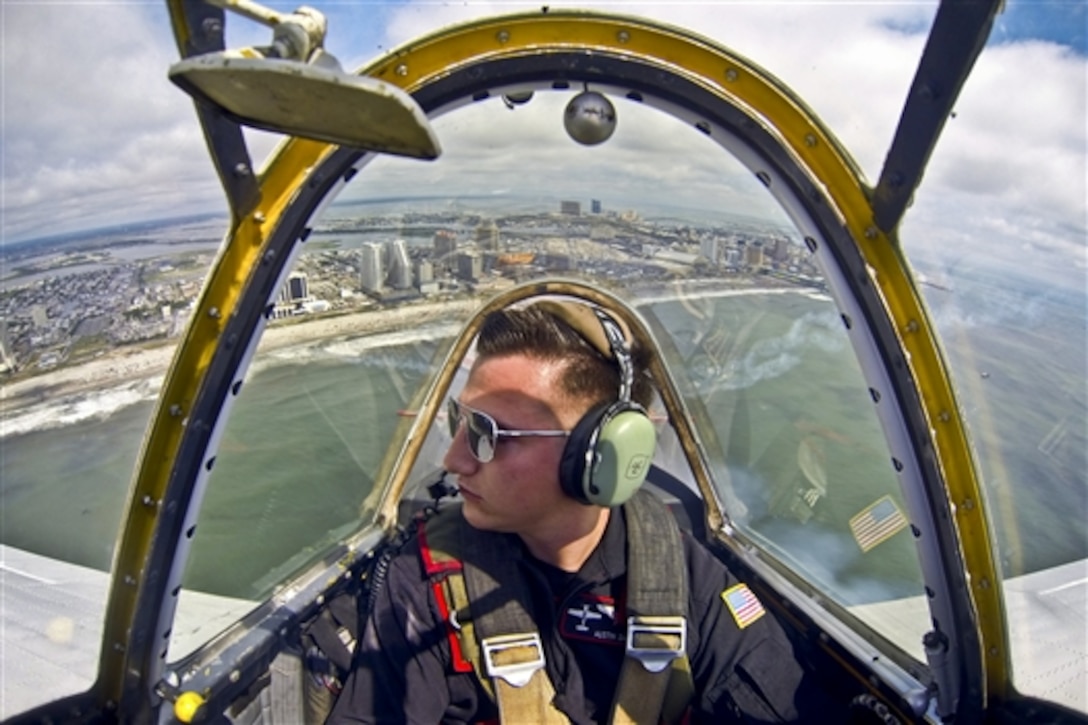 Airman Austin Daniel flies with the Raiders Demonstration Team in his Yak-52 demonstration aircraft  for the "Thunder Over the Boardwalk Air Show" over Atlantic City, N.J., Aug. 13, 2014.  Daniel is an F-16C Fighting Falcon crew chief assigned to New Jersey Air National Guard's 177th Fighter Wing. 