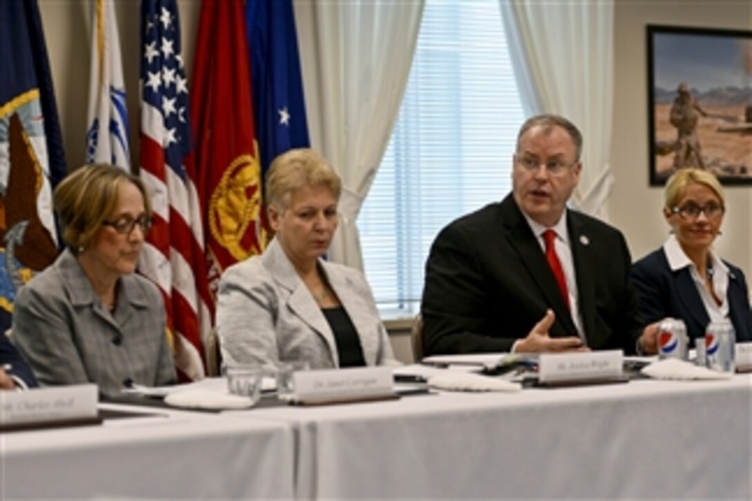 Deputy Defense Secretary Bob Work meets with members of veterans service organizations during a round-table meeting at the Pentagon, Aug. 14, 2014