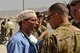 U.S. Air Force Lt. Col. Keyan Riley, 455th Expeditionary Medical Group, deputy commander for Clinical Services, speaks with U.S. Army Maj. Mark Rivera, from the 159th Combat Aviation Brigade, about the transfer of patients from helicopters to the emergency department of the Craig Joint Theater Hospital, Afghanistan Aug. 5, 2014. Service members assigned to CJTH and 159th Combat Aviation Brigade, “DUSTOFF,” teamed together to administer emergency care for victims of a mass casualty. Riley is deployed form the U.S. Air Force Academy, Colo. (U.S. Air Force photo by Maj. Brandon Lingle/Released)