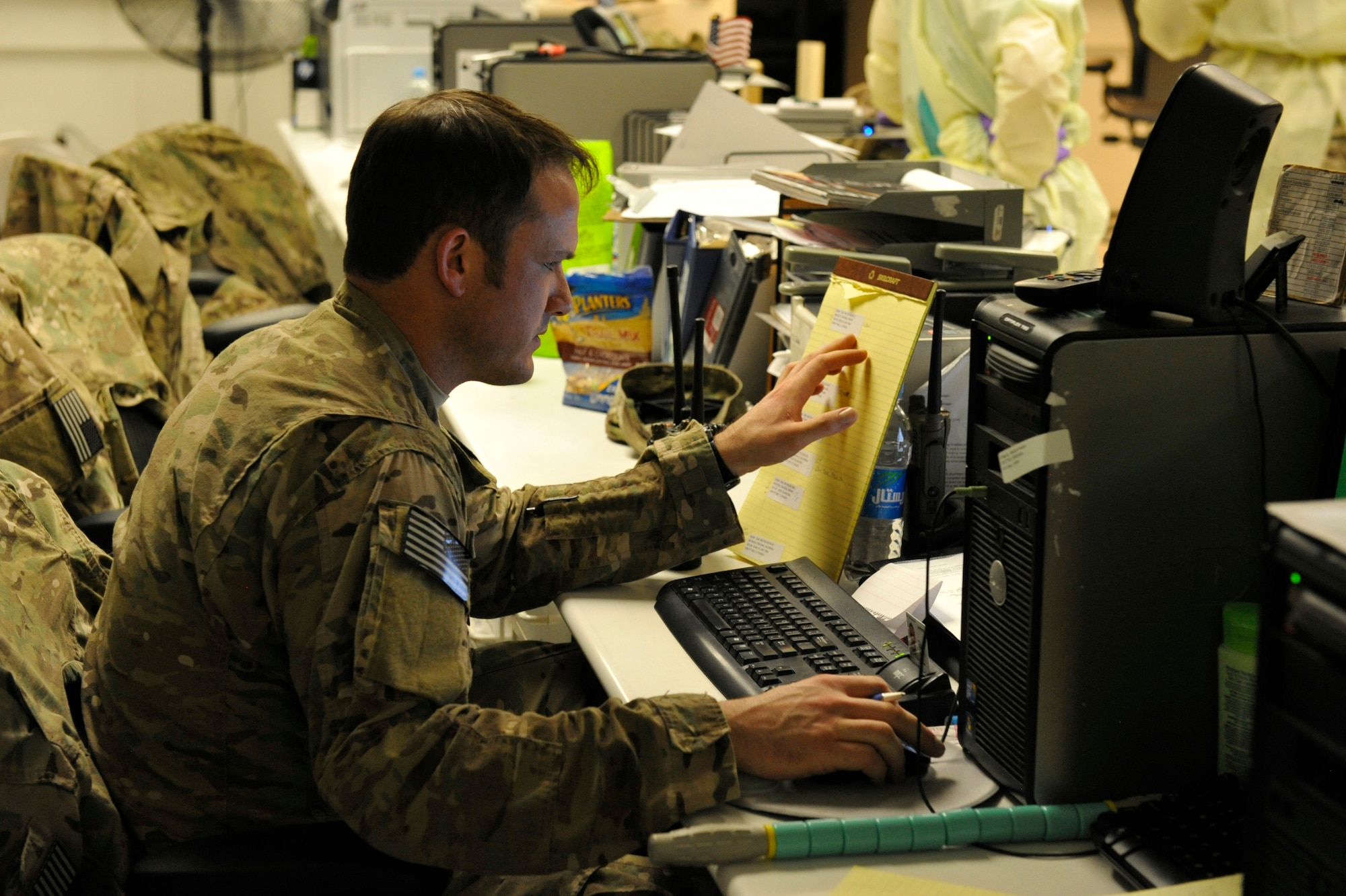 U.S. Air Force Staff Sgt. Travis Smith, 455th Expeditionary Medical Group aerospace medical service technician, tracks trauma patient status during a mass casualty response at the Craig Joint Theater Hospital at Bagram Airfield, Afghanistan Aug. 5, 2014. Smith is deployed from Joint Base San Antonio, Texas. (U.S. Air Force photo by Maj. Brandon Lingle/Released)