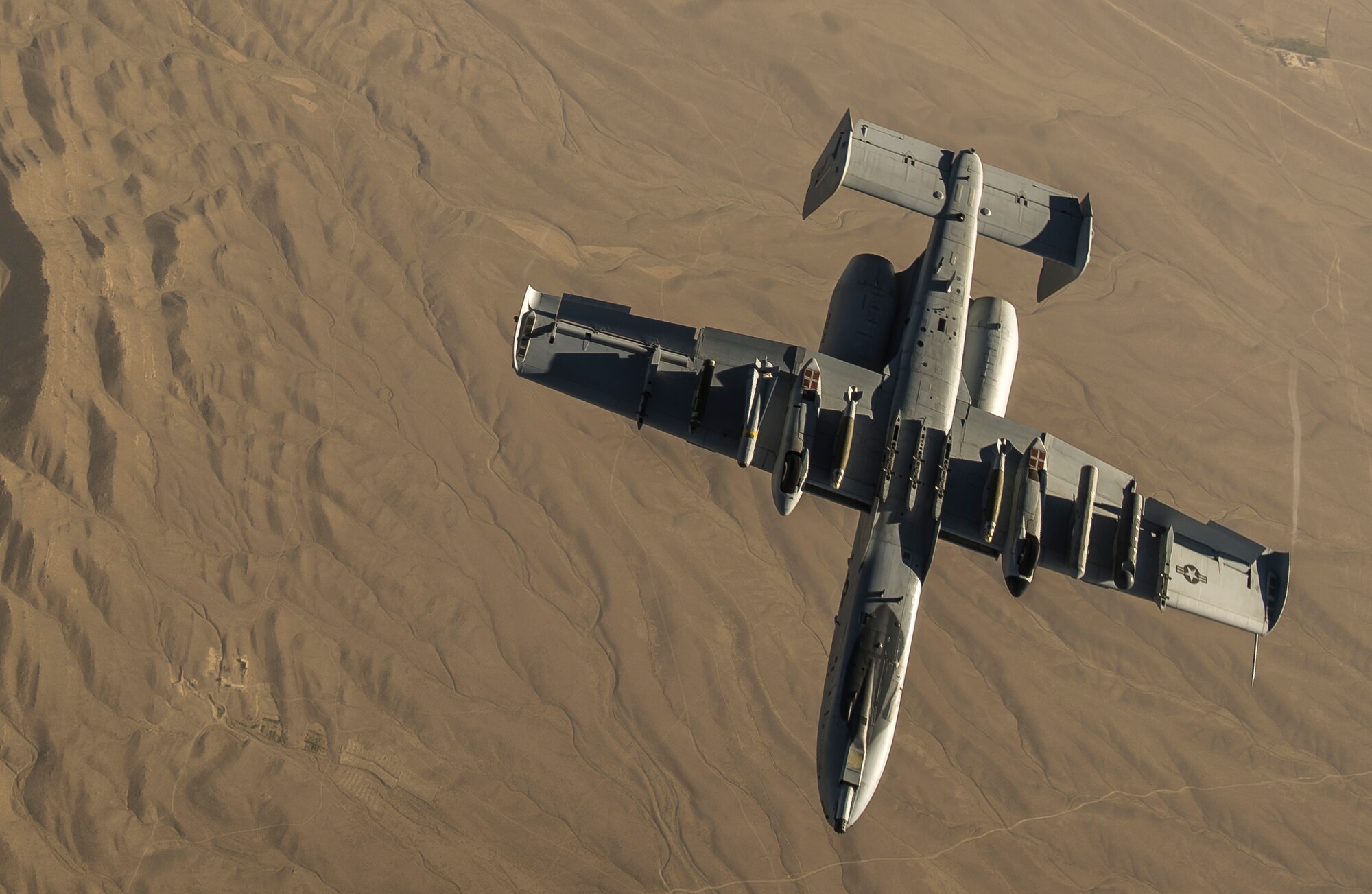 A U.S. Air Force A-10 Thunderbolt II with the 303rd Expeditionary Fighter Squadron, Bagram Airfield, Afghanistan, peels away from a KC-135 Stratotanker over Eastern Afghanistan, July 10, 2014. The A-10's maneuverability at slow speeds and low altitude has made it one of the most utilized aircraft for close air support throughout Operation Enduring Freedom. (U.S. Air Force photo by Senior Airman Matthew Bruch/Released)