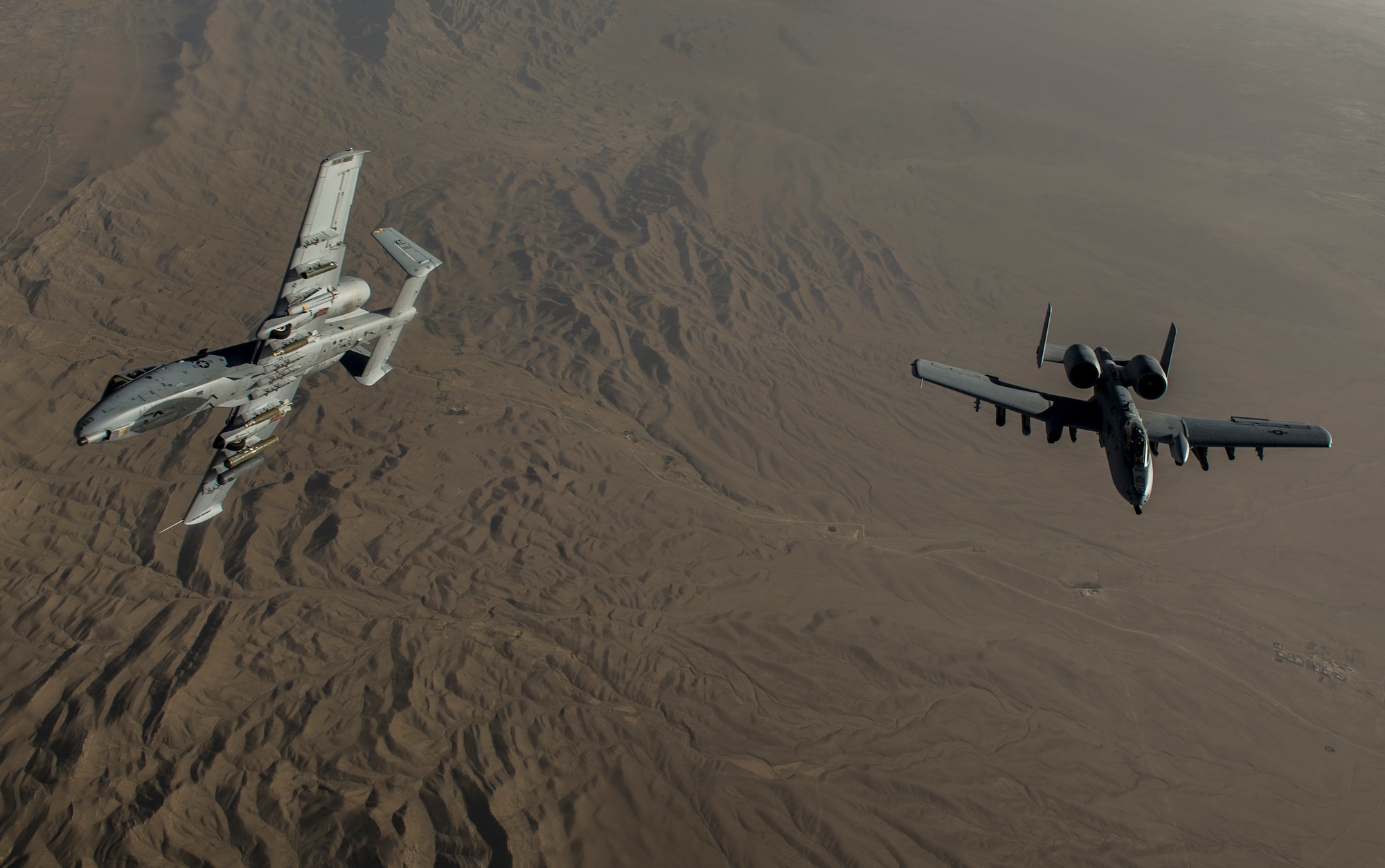 Two U.S. Air Force A-10 Thunderbolt II's with the 303rd Expeditionary Fighter Squadron, Bagram Airfield, Afghanistan, patrol the skies of eastern Afghanistan, July 10, 2014.The A-10's maneuverability at slow speeds and low altitude has made it one of the most utilized aircraft for close air support throughout Operation Enduring Freedom. (U.S. Air Force photo by Senior Airman Matthew Bruch/Released)