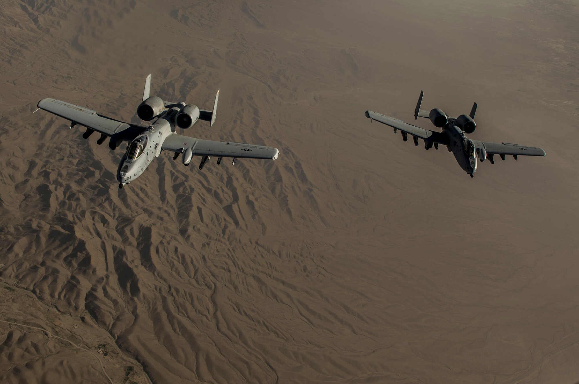Two U.S. Air Force A-10 Thunderbolt II's with the 303rd Expeditionary Fighter Squadron, Bagram Airfield, Afghanistan, fly in formation behind a KC-135 after conducting an air-to-air refueling over the skies of eastern Afghanistan, July 10, 2014. The A-10's maneuverability at slow speeds and low altitude has made it one of the most utilized aircraft for close air support throughout Operation Enduring Freedom. (U.S. Air Force photo by Senior Airman Matthew Bruch/Released)