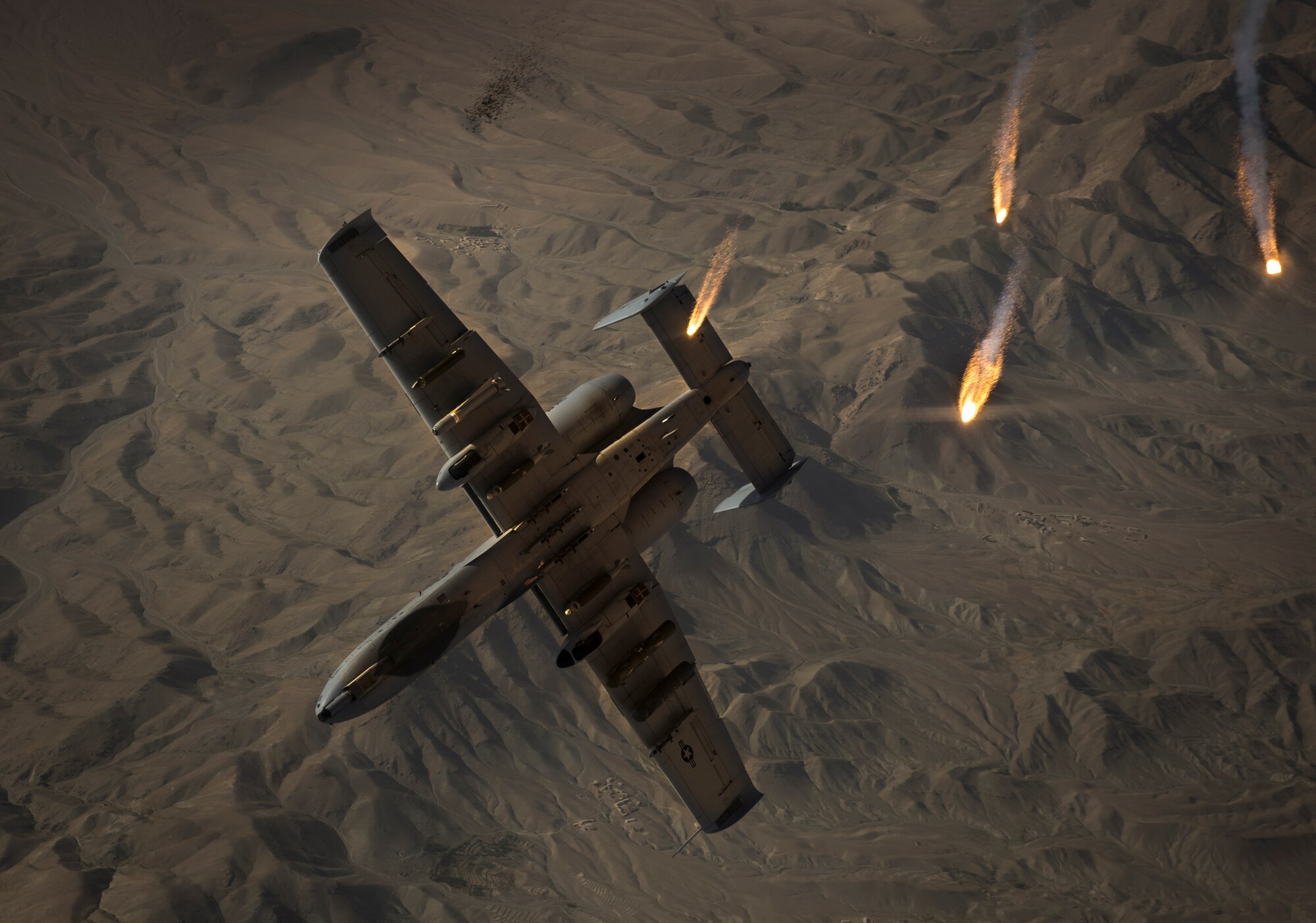 A U.S. Air Force A-10 Thunderbolt II with the 303rd Expeditionary Fighter Squadron, Bagram Airfield, Afghanistan, peels away and pops flares after receiving fuel from a KC-135 Stratotanker from the 340th Expeditionary Air Refueling Squadron out of Al Udeid Air Base, Qatar over Eastern Afghanistan, July 10, 2014. The A-10's maneuverability at slow speeds and low altitude has made it one of the most utilized aircraft for close air support throughout Operation Enduring Freedom. (U.S. Air Force photo by Senior Airman Matthew Bruch/Released)
