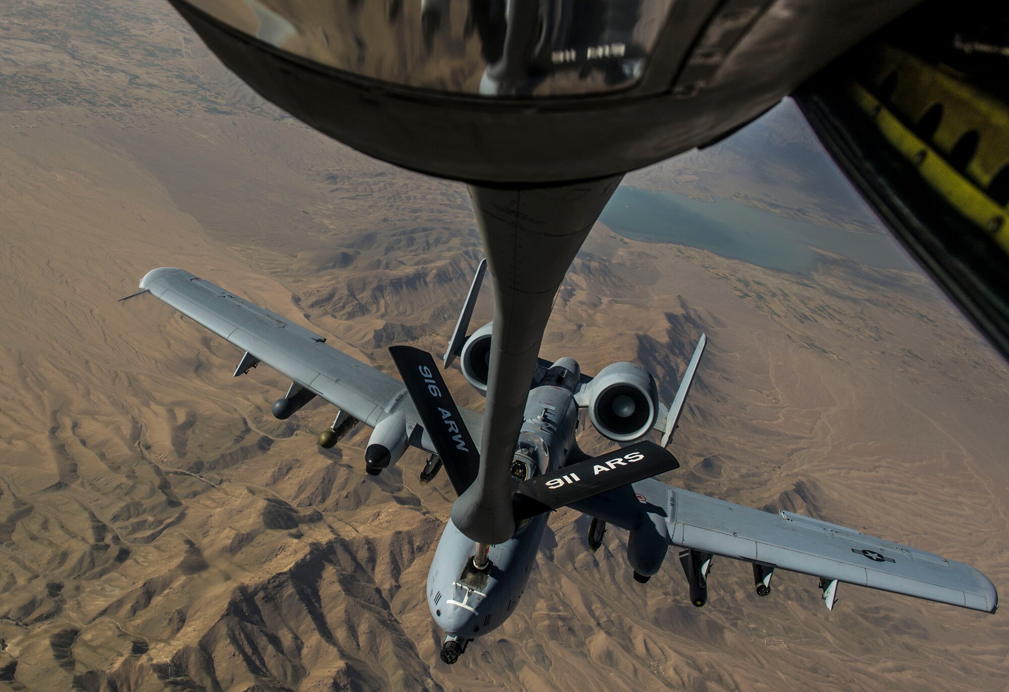 A U.S. Air Force A-10 Thunderbolt II with the 303rd Expeditionary Fighter Squadron, Bagram Airfield, Afghanistan, receives fuel from a KC-135 Stratotanker from the 340th Expeditionary Air Refueling Squadron out of Al Udeid Air Base, Qatar over Eastern Afghanistan, July 10, 2014. The A-10's maneuverability at slow speeds and low altitude has made it one of the most utilized aircraft for close air support throughout Operation Enduring Freedom. (U.S. Air Force photo by Senior Airman Matthew Bruch/Released)