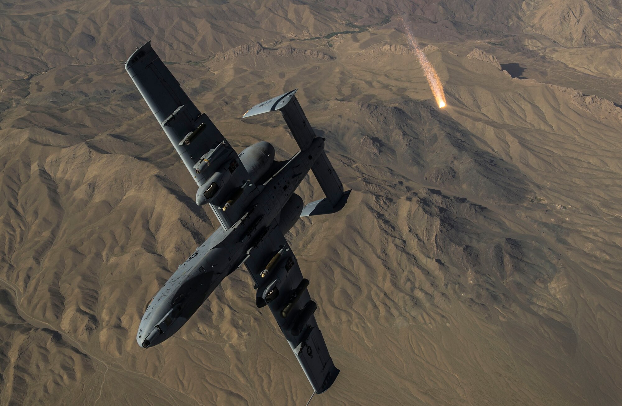 A U.S. Air Force A-10 Thunderbolt II with the 303rd Expeditionary Fighter Squadron, Bagram Airfield, Afghanistan, peels away and pops flares after receiving fuel from a KC-135 Stratotanker from the 340th Expeditionary Air Refueling Squadron out of Al Udeid Air Base, Qatar over Eastern Afghanistan, July 10, 2014 The A-10's maneuverability at slow speeds and low altitude has made it one of the most utilized aircraft for close air support throughout Operation Enduring Freedom. (U.S. Air Force photo by Senior Airman Matthew Bruch/Released)