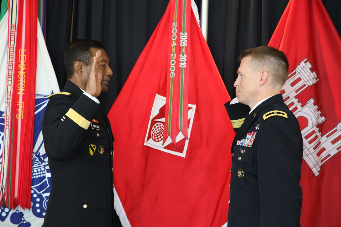 Lt. Gen. Thomas P. Bostick (left), commanding general of the U.S.  Army Corps of Engineers administers the Army Officer’s Oath of Office to Brig. Gen. David C. Hill in a ceremony Aug. 8 at Fort Belvoir, Va.  