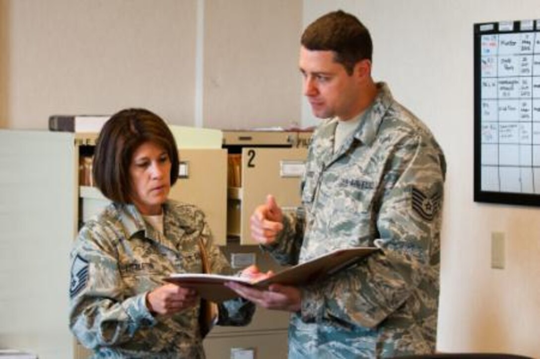 Law Office Superintendent MSgt Elizabeth Littleton, and Paralegal Tech. Sgt. Stephen Signaigo, both with the 164th Air Wing legal office, examine case files on Joint Base Elmendorf-Richardson (JBER), Alaska, July 16, 2014. Littleton and Signaigo were attending their two week annual training on JBER. (U.S. Air National Guard photo by Staff Sgt Allan Eason/Released)




