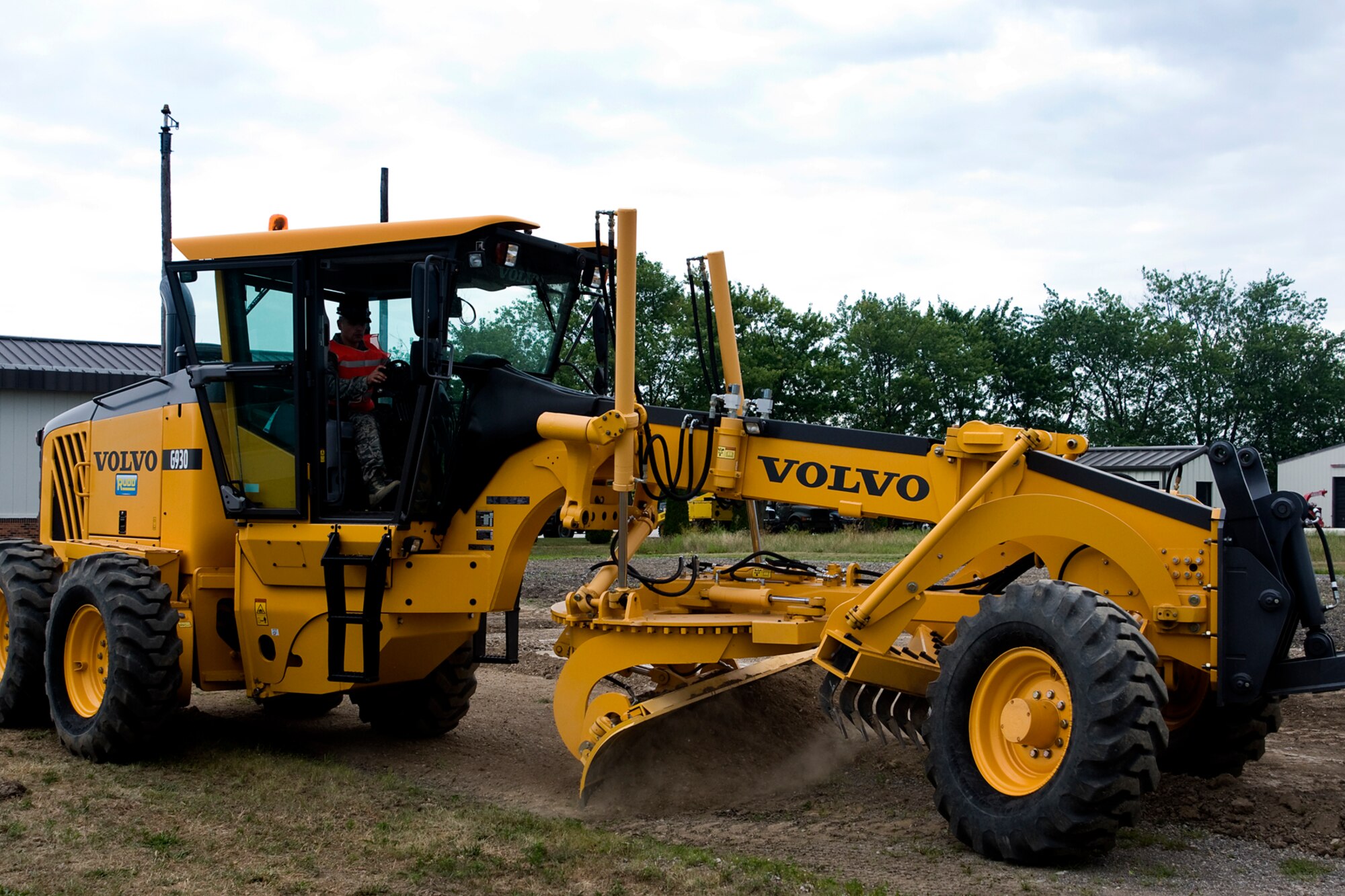 Staff Sgt. Christian Navarro, 434th Civil Engineer Squadron pavements and construction journeyman, operates a grader to smooth the surface area of an explosive ordnance disposal training area at Grissom Air Reserve Base, Ind., Aug. 10, 2014. The site provides an area where Grissom EOD technicians can conduct necessary training. (U.S. Air Force photo/Staff Sgt. Andrew McLaughlin)
