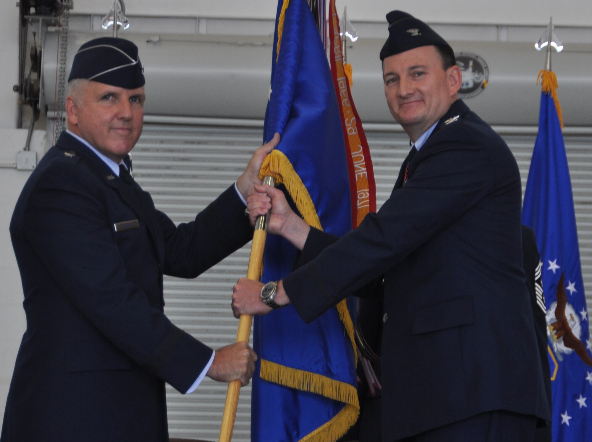 Brigadier Gen. John C. Flournoy, 4th Air Force commander and presiding officer, passes the 459th Air Refueling Wing guide-on to Colonel Thomas K. "TK" Smith, Jr., August 16, 2014, at the change of command ceremony held in Hangar. Prior to coming to the 459th Air Refueling Wing, Smith was commander of the 507th Operations Group, Tinker Air Force Base, Oklahoma. (U.S. Air Force photo/ Staff Sgt. Amber J. Russell)