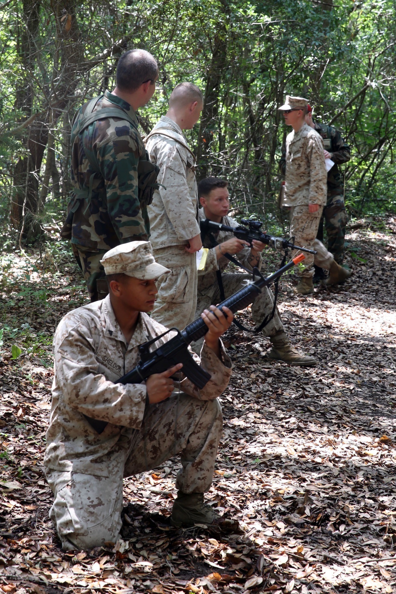 Marines from 2nd Battalion, 2nd Marine Regiment, 2nd Marine Division demonstrate proper weapons handling to role players during the unit's Military Readiness Exercise June 9-12 at Marine Corps Auxiliary Landing Field Bogue. The Marines handled several scenarios presented by the role players, and acted accordingly while continuing the mission. (U.S. Marine Corps photo by Lance Cpl. Ryan Young/released)


