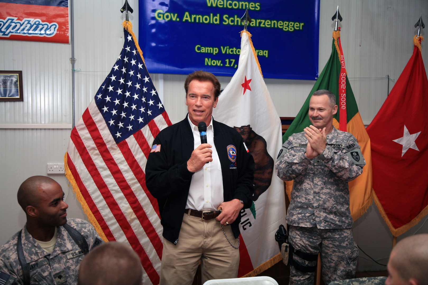 California Gov. Arnold Scharzenegger greets Soldiers from the 49th Military Police Brigade of the California National Guard at the Oasis dining facility at Camp Victory, Iraq Nov. 15, 2009. He announced today a new state initiative to better help returning combat veterans to land jobs and get whatever help they need in securing housing, health care and other veterans' services.