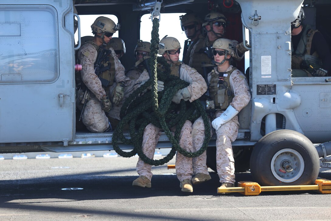 Marines with the reconnaissance detachment, 11th Marine Expeditionary Unit, sit in a MH-60S Seahawk before conducting a modified fast-rope training exercise as part of the MEU's WESTPAC 14-2 deployment aboard the USS Makin Island Aug. 14, 2014. The 11th MEU and Makin Island Amphibious Ready Group are deployed to the 7th Fleet area of operations as a sea based, expeditionary crisis response force capable of conducting amphibious missions across the full range of military operations. (U.S. Marine Corps photo by Cpl. Demetrius Morgan/RELEASED