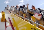 Bound for Ft. Hood, Texas, and then Kuwait, Soldiers from 1st Battalion, 124th Infantry Regiment say goodbye to family and board a plane, Tuesday afternoon, at the Ft. Lauderdale International Airport, Jan. 5, 2009