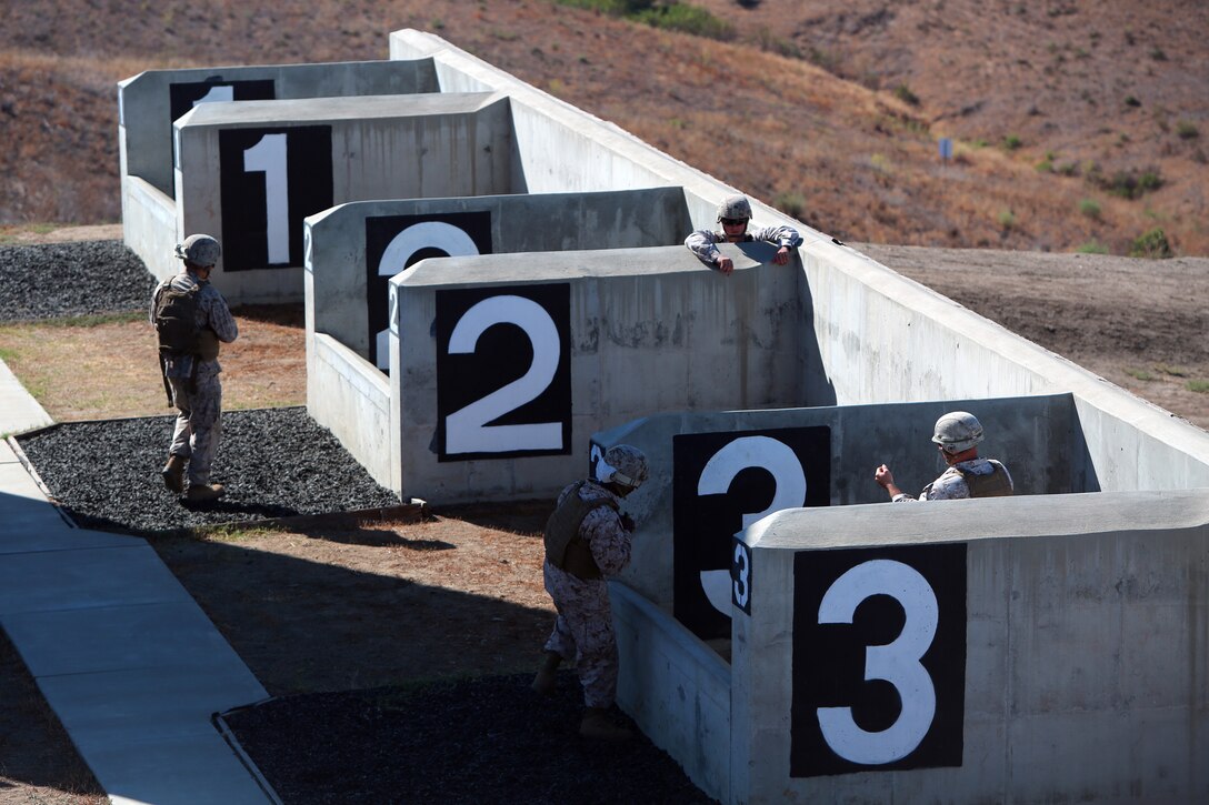 Marines with 9th Communication Battalion, I Marine Expeditionary Force, make their way to the pits to throw grenades aboard Marine Corps Base Camp Pendleton, Calif., Aug. 14, 2014. The communication Marines were trained by 1st Marine Division Schools as part of an annual training event to prepare them to react to various combat situations with confidence.