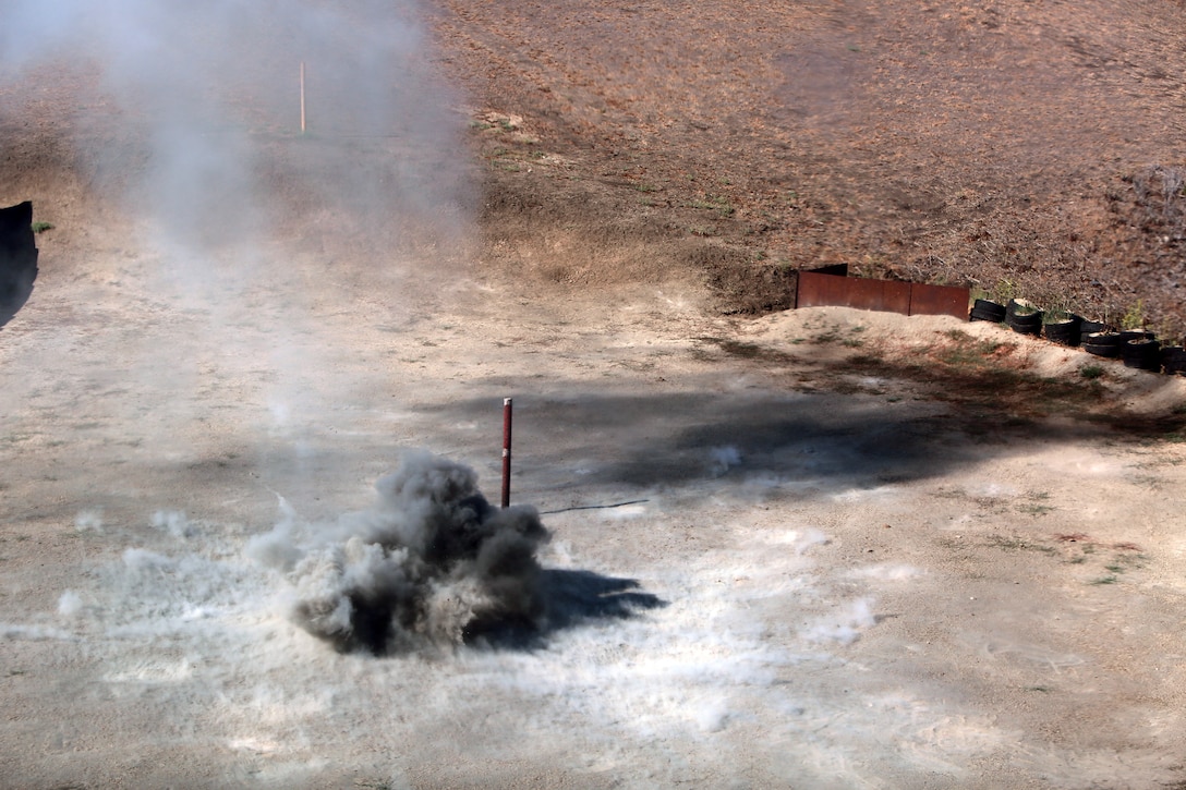 Grenades detonate down range after being thrown by Marines with 9th Communication Battalion, I Marine Expeditionary Force, aboard Marine Corps Base Camp Pendleton, Calif., Aug. 14, 2014. The communications Marines were trained by 1st Marine Division Schools as part of an annual training event to prepare them to react to various combat situations with confidence.
