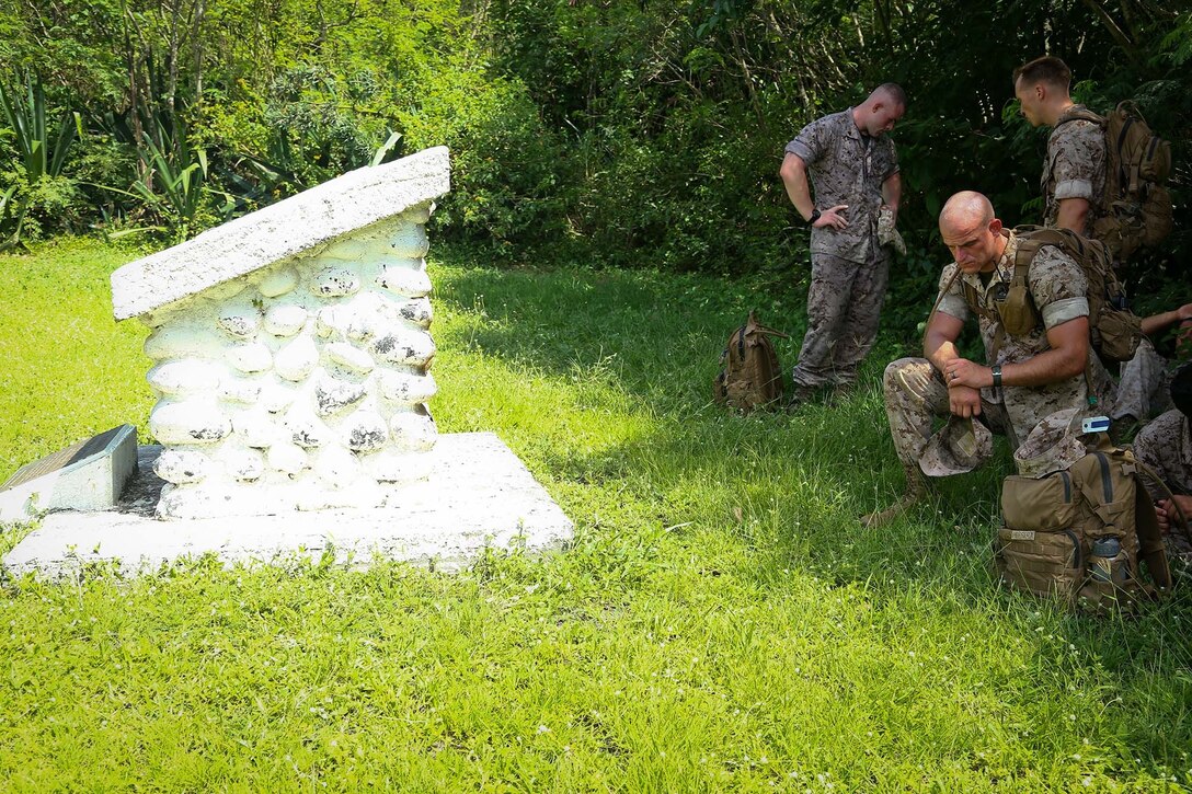 Marines with the 11th Marine Expeditionary Unit pay their respects to those who served in the battle of Iwo Jima on their way toward Mount Suribachi, Iwo To, Japan as part of the MEU’s WESTPAC 14-2 deployment Aug. 16, 2014. The 11th MEU and Makin Island Amphibious Ready Group are deployed to the U.S. 7th Fleet area of operations as a sea-based, expeditionary crisis response force capable of conducting amphibious missions across the full range of military operations.    (U.S. Marine Corps photo by Lance Cpl. Laura Raga/Released)