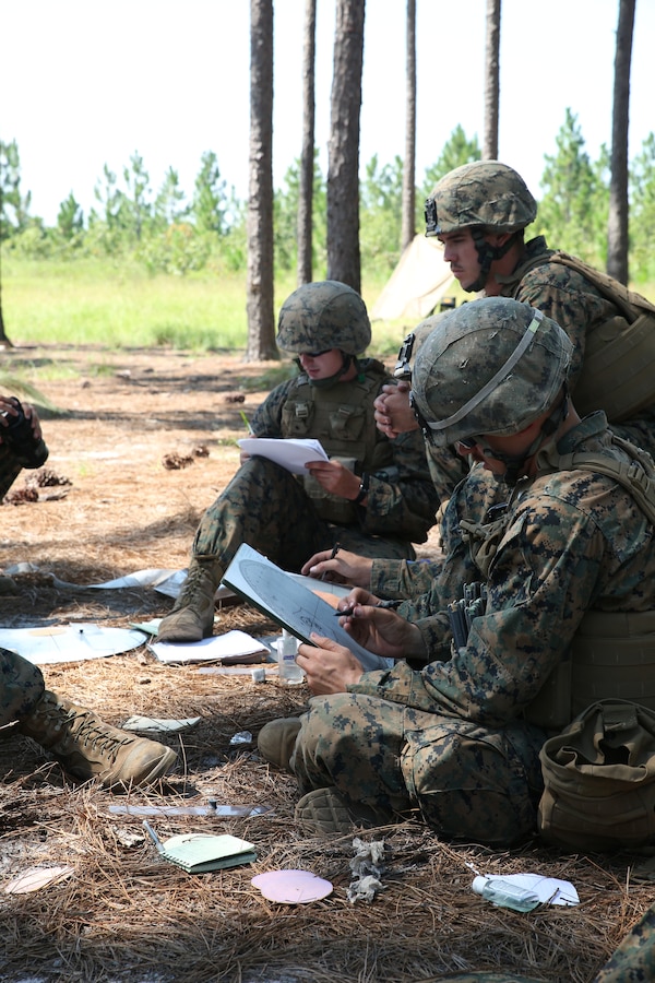 A squad of Marine mortarmen with Weapons Company, 1st Battalion, 24th Marine Regiment, assumes the role of a fire direction center as part of an indirect-fire weapons integration exercise Aug. 15, 2014, aboard Camp Lejeune, N.C., during exercise Heavy Metal 14. The FDC coordinates with forward observers to send grid coordinates to gun crews to accurately place rounds down range.