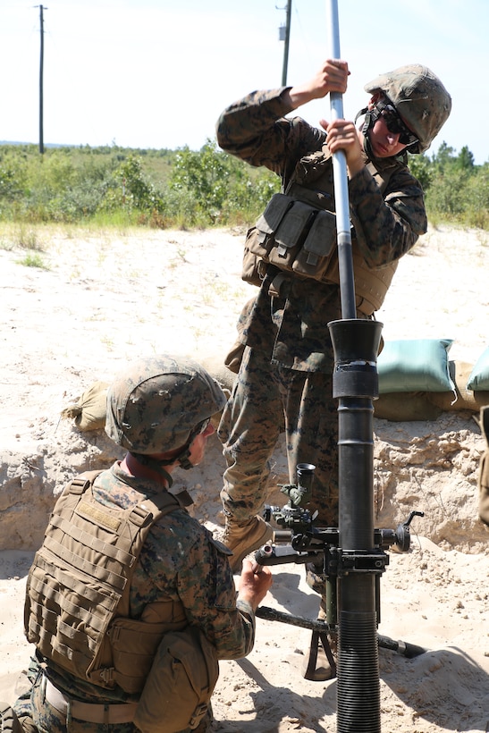 Marine mortarmen with Weapons Company, 1st Battalion, 24th Marine Regiment clean the bore of their mortar tube after firing during an indirect fire weapons integration exercise Aug. 15, 2014, aboard Camp Lejeune, N.C., during exercise Heavy Metal 14. The tube is cleaned after each fire-for-effect mission to ensure no debris entered while firing rapidly.