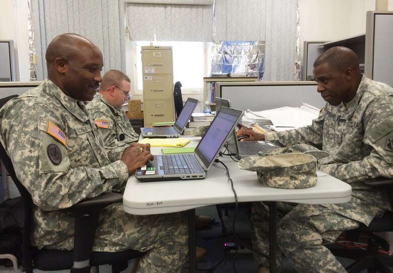 Soldiers from the 249th Engineer Battalion - Prime Power, Alpha Company, 249th Mission Command Node,  monitor emergency response operations from their workstations inside the Honolulu District Emergency Operations Center. From left to right are: Master Sgt. Jamie Cosey, Staff Sgt. Shawn Truesdell, and Chief Warrant Officer 2 Springette Ulston. In response to Hurricane Iselle, the U.S. Army Corps of Engineers, Honolulu District fielded multiple assets to assist the U.S. Coast Guard, Hawaii State Civil Defense, FEMA, and other federal, state, and local agencies. The Honolulu District, working with our local and federal partners, jointly conducted an underwater survey in Hilo Harbor on Aug. 8 and ensured there were no channel obstructions. Based on the successful results of this survey, the Coast Guard reopened Hilo Harbor the same day allowing vessel traffic to safely resume. The District, teaming with the 249th Engineer Battalion - Prime Power, also worked with state and federal officials to assist their efforts in restoring power in affected areas.