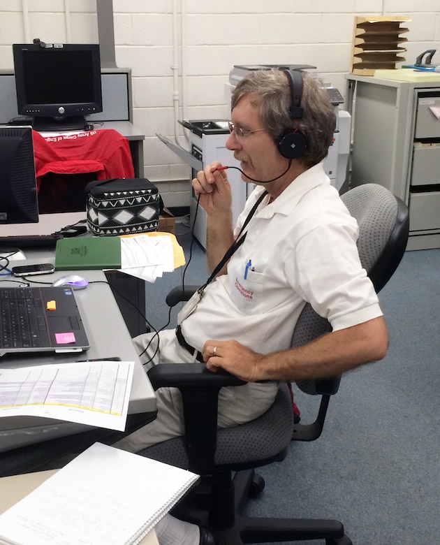 Honolulu District's Donald Schlack, the District's subject matter expert for Emergency Power, talks with emergency respone officials at his workstation in the Honolulu District Emergency Operations Center. In response to Hurricane Iselle, the U.S. Army Corps of Engineers, Honolulu District fielded multiple assets to assist the U.S. Coast Guard, Hawaii State Civil Defense, FEMA, and other federal, state, and local agencies. The Honolulu District, working with our local and federal partners, jointly conducted an underwater survey in Hilo Harbor on Aug. 8 and ensured there were no channel obstructions. Based on the successful results of this survey, the Coast Guard reopened Hilo Harbor the same day allowing vessel traffic to safely resume. The District, teaming with the 249th Engineer Battalion - Prime Power, also worked with state and federal officials to assist their efforts in restoring power in affected areas. 