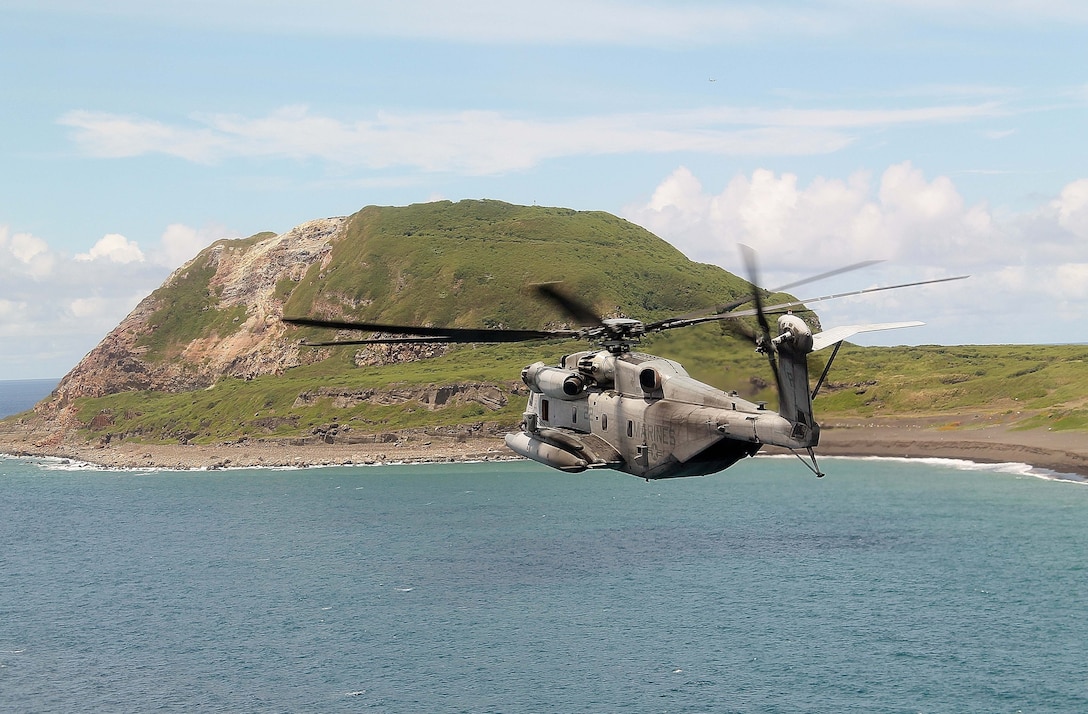 A CH-53E Super Stallion from Marine Medium Tiltrotor Squadron 163 (Reinforced), 11th Marine Expeditionary Unit, flies past Mount Suribachi Aug. 16 at Iwo To, Japan, as part of the MEU’s WESTPAC 14-2 deployment in the 7th Fleet area of operations. The 11th MEU and Makin Island Amphibious Ready Group are deployed to the 7th Fleet area of operations as a sea-based, expeditionary crisis response force capable of conducting amphibious missions across the full range of military operations. (U.S. Marine Corps photo by Capt. Kenneth P. Mateo/RELEASED)
