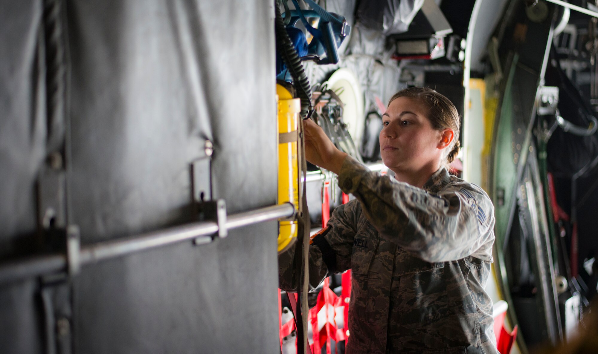 Senior Airman Katie Powell, 374th Operations Support Squadron aircrew flight equipment specialist, inspects oxygen masks on a C-130 Hercules prior to take off during Exercise RED FLAG-Alaska on Aug. 5, 2014 at Joint Base Elmendorf-Richardson, Alaska. Powell, assigned to the 36th Airlift Squadron during the exercise, was the only AFE specialist from Yokota Air Base. (U.S. Air Force photo by Staff Sgt. Chad C. Strohmeyer/Released)