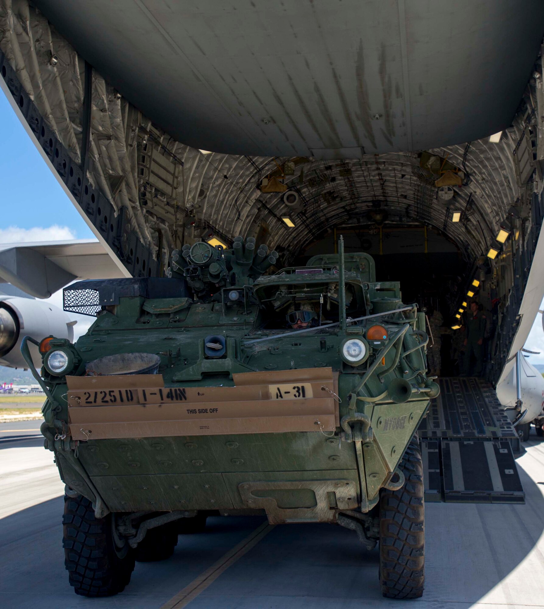 A U.S. Army Stryker combat vehicle is guided into a C-17 Globemaster III from the 535th Airlift Squadron during a 25th Infantry Division training exercise on the Joint Base Pearl Harbor-Hickam, Hawaii, flightline Aug. 13, 2014. The Stryker, the Army’s Interim Armored Vehicle, is used to provide quick response maneuvering capability, enhanced survivability and lethality and expand fight versatility. (U.S. Air Force photo by Tech. Sgt. Terri Paden)